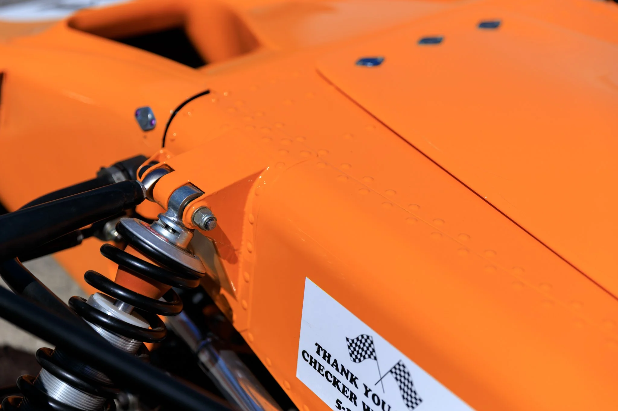 McLaren M21 Formula 2, chassis M21-3 — close detail of right side bodywork, Papaya Orange
