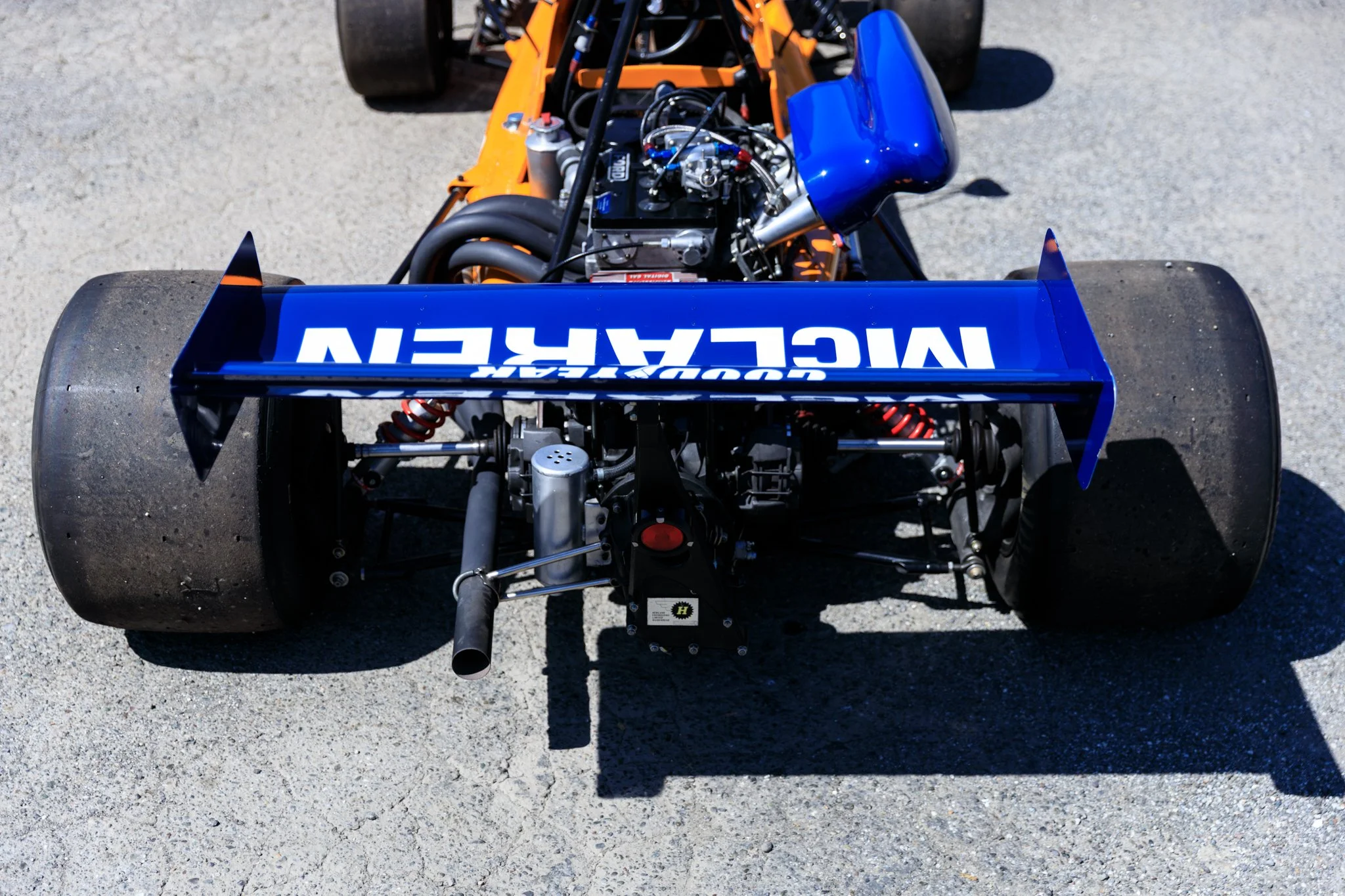McLaren M21 Formula 2, chassis M21-3 — overhead rear view showing Cosworth BDG engine, blue rear wing with McLaren lettering, suspension detail