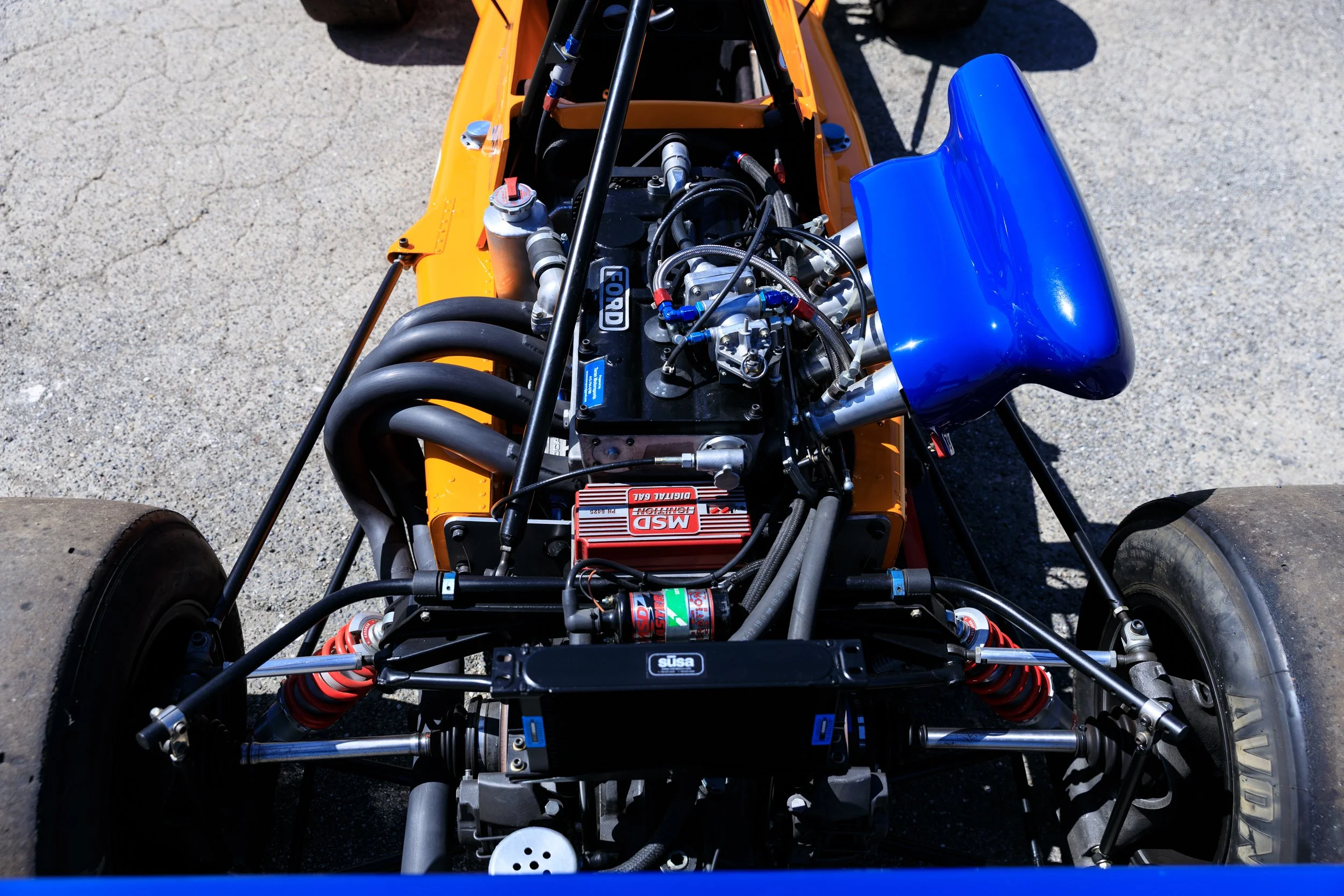 McLaren M21 Formula 2, chassis M21-3 — right side engine bay detail, Cosworth BDG engine, blue airbox, Papaya Orange bodywork