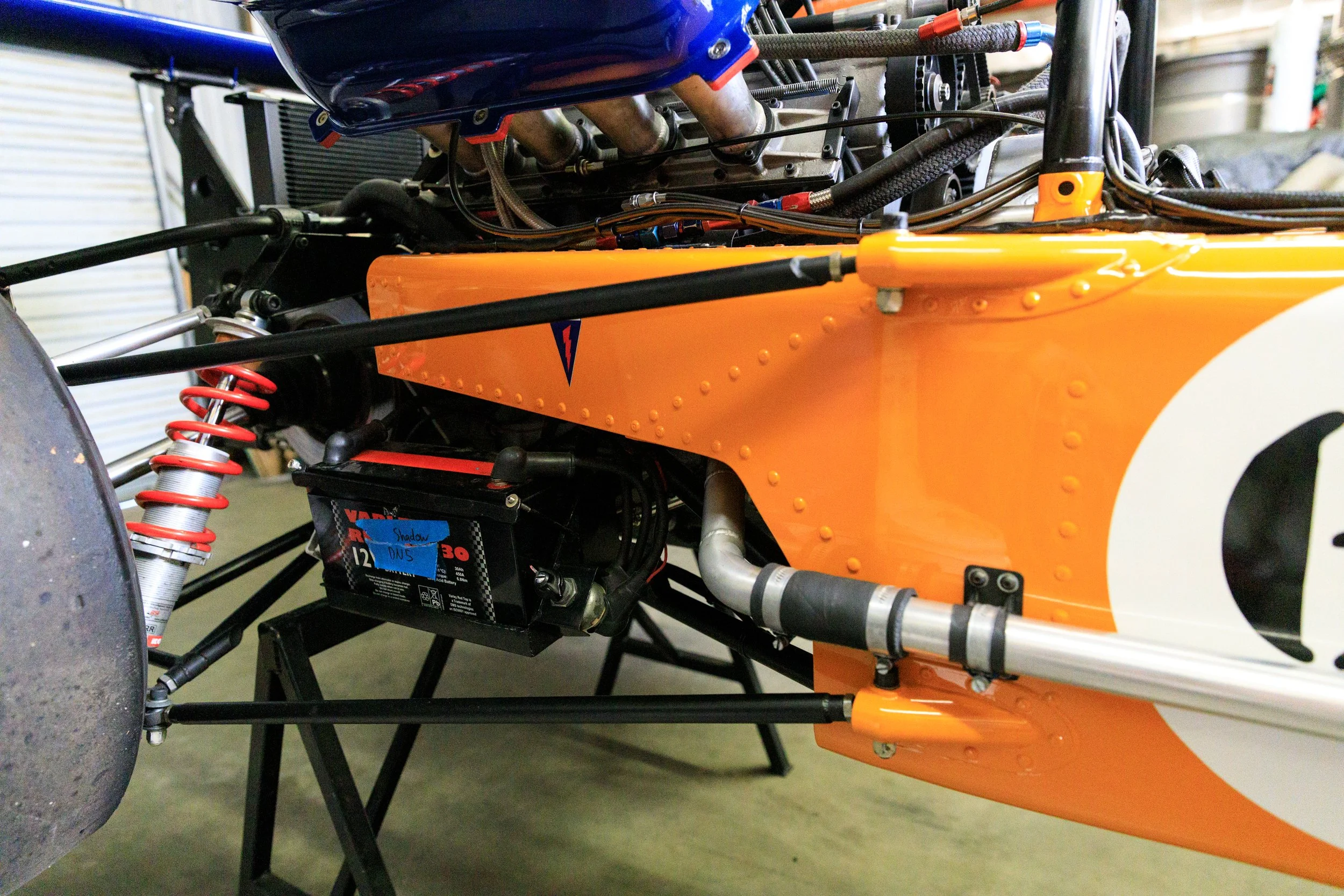 McLaren M21 Formula 2, chassis M21-3 — rear suspension and gearbox detail, Hewland gearbox visible, Papaya Orange bodywork