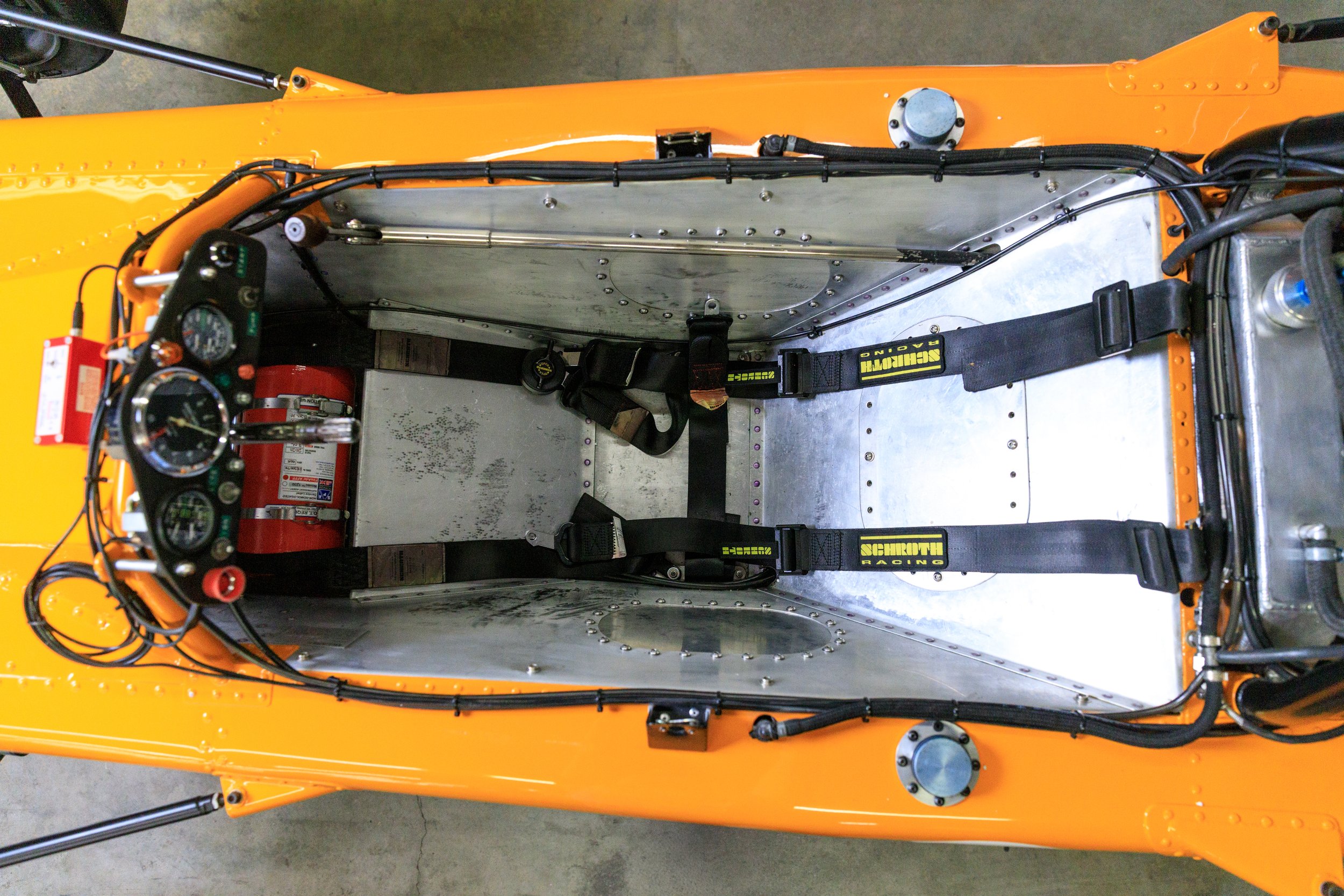 McLaren M21 Formula 2, chassis M21-3 — cockpit interior showing aluminium monocoque tub, harness mounting points, footwell and pedal area