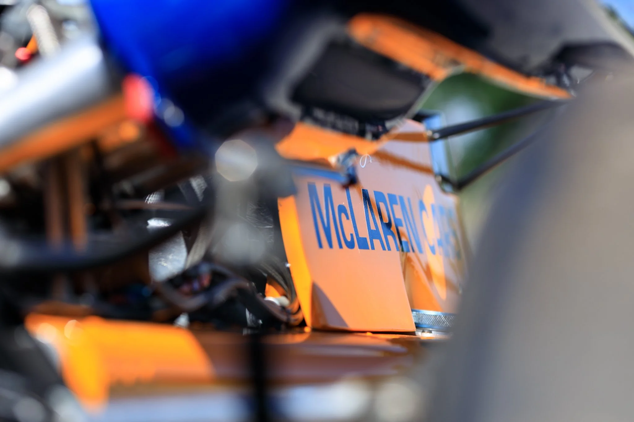 McLaren M21 Formula 2, chassis M21-3 — detail of left sidepod McLaren Cars lettering, Papaya Orange