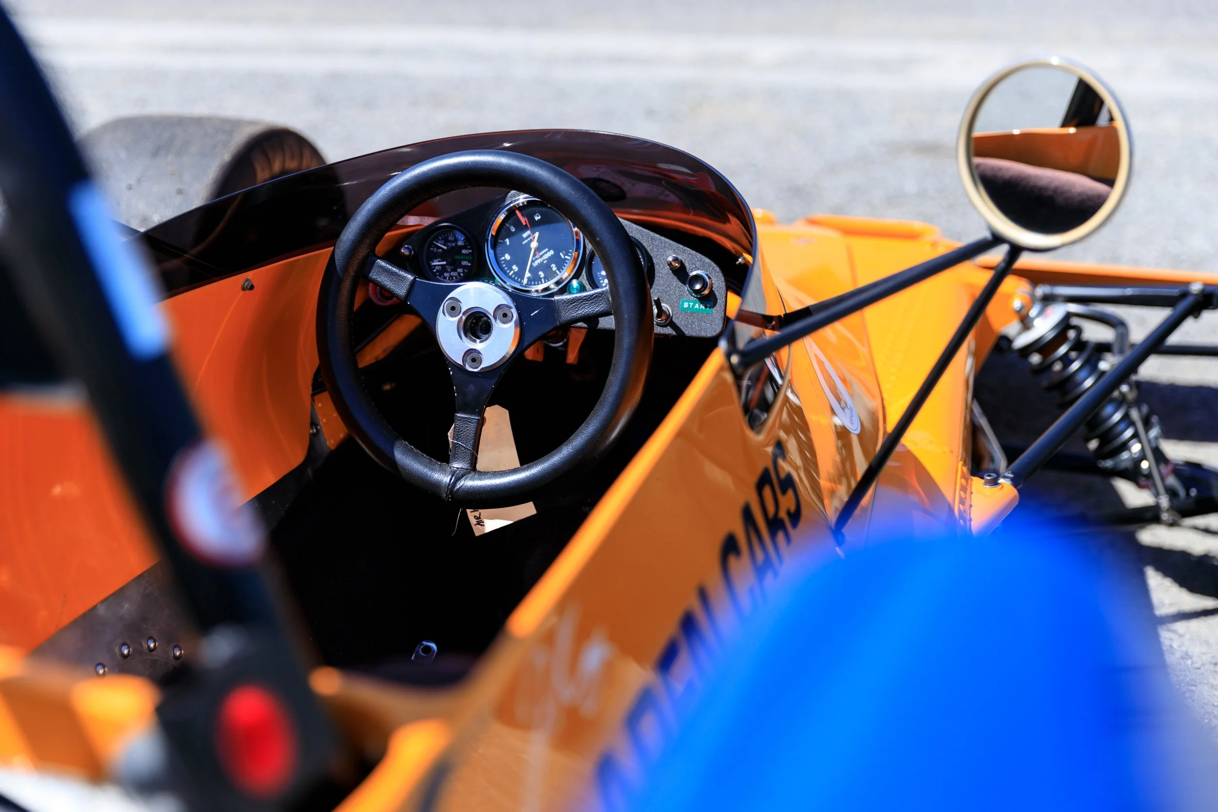 McLaren M21 Formula 2, chassis M21-3 — cockpit detail from left side, steering wheel, instruments, McLaren Cars sidepod lettering visible