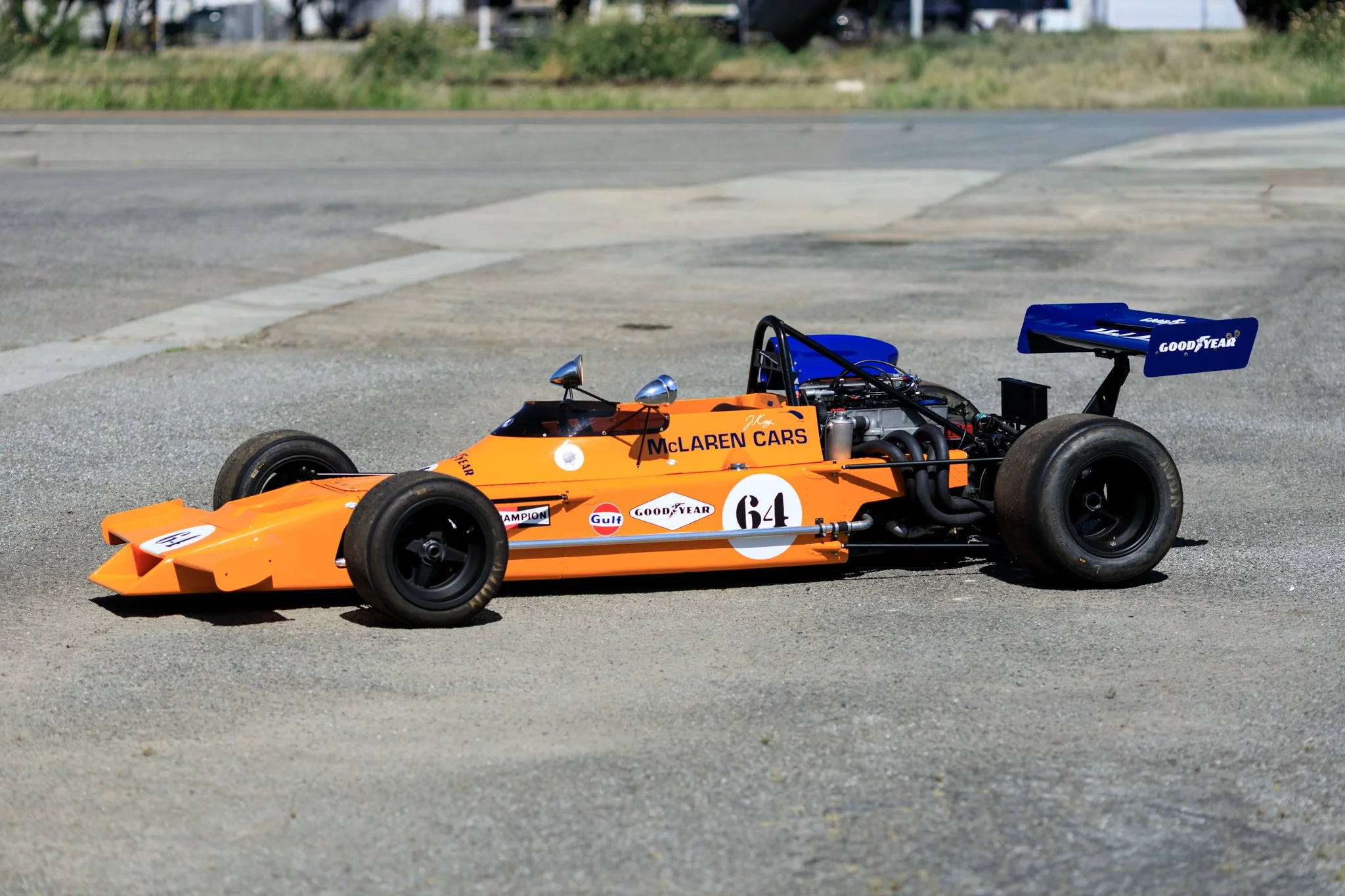 McLaren M21 Formula 2 for sale. Chassis M21-3. Papaya Orange. Cosworth BDG. Teran Motorsports. Mitchell Curated. side view on track