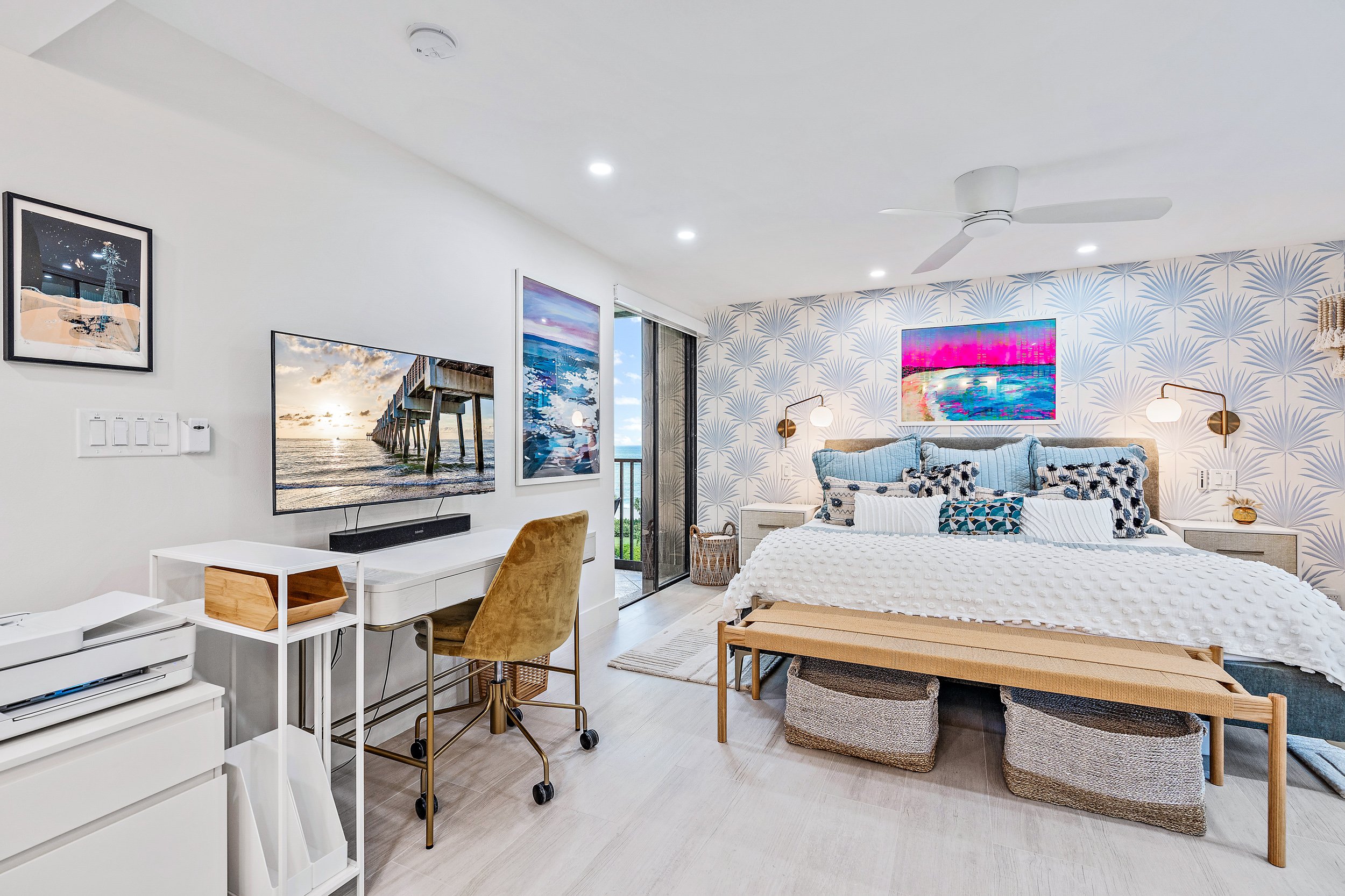 Primary Bedroom Featuring a Full Home Office Set-Up With Printer, Docking Station and TV Which Doubles as a Monitor