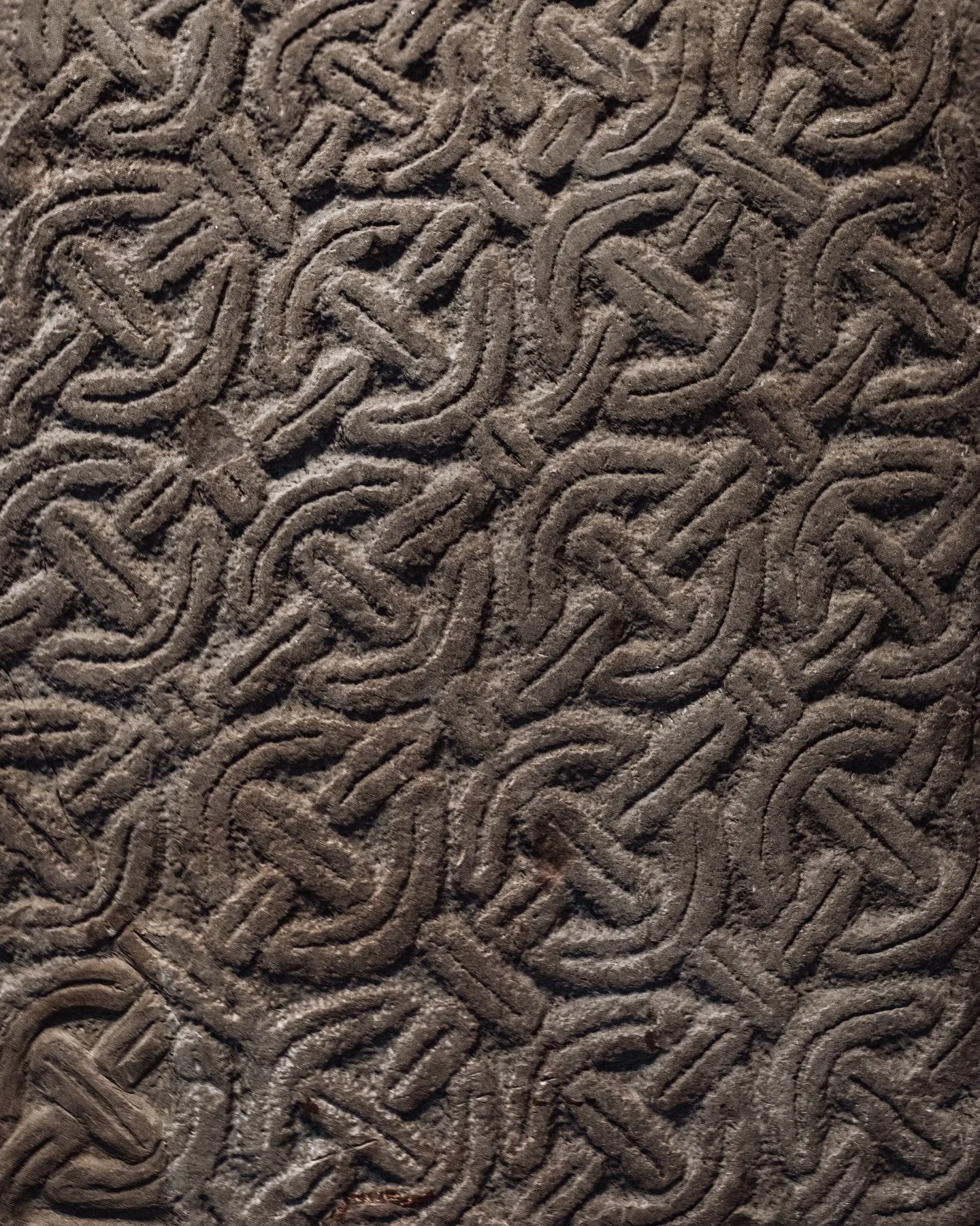 These intricately carved stones are early medieval Celtic cross-slabs, dating from roughly the 6th to 9th centuries CE. The designs were heavily inspired from Pictish art but gradually were more influenced by early Christianity... trading animal moti