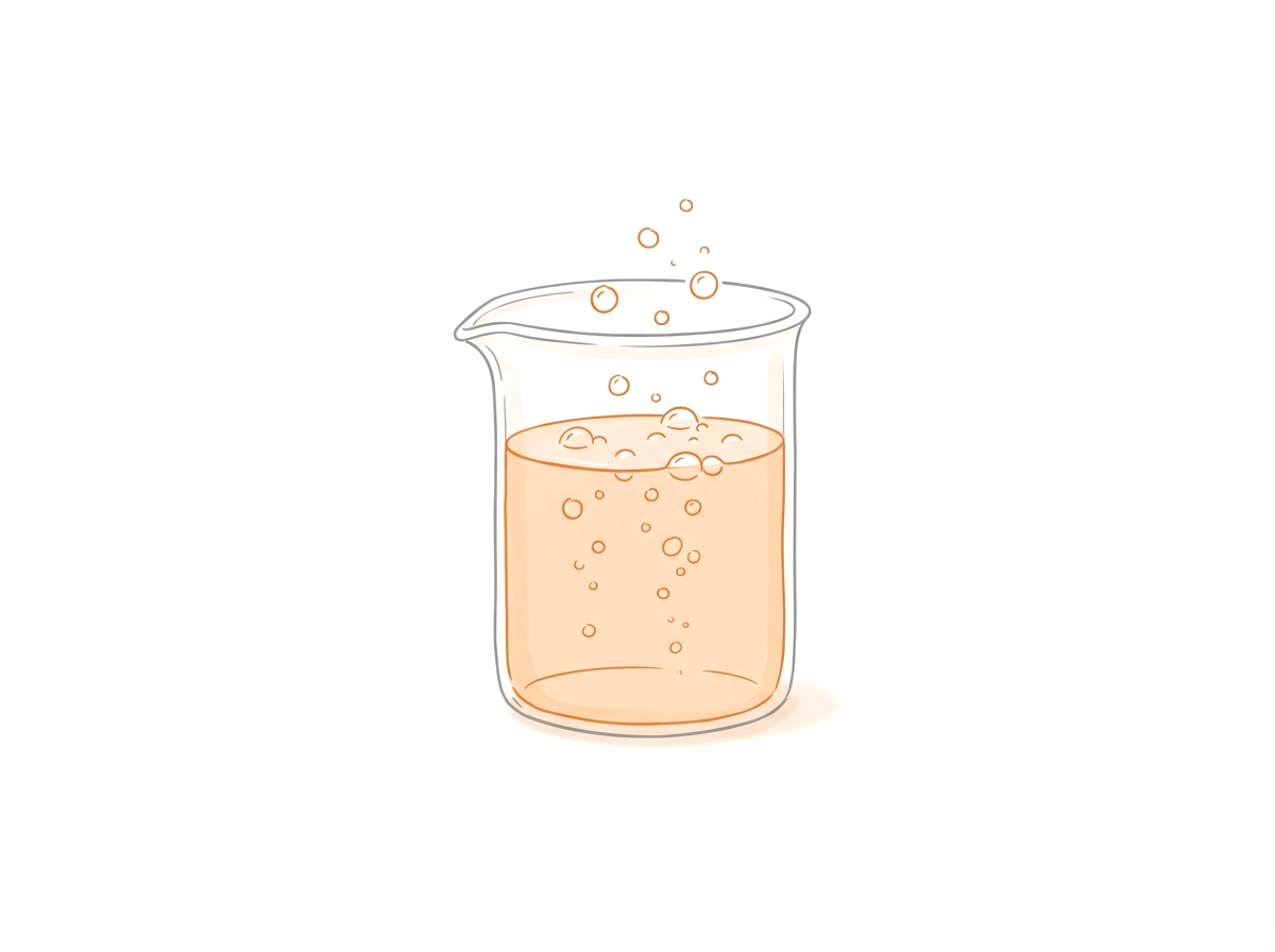 Light orange beaker with bubbles on a white backgrouond