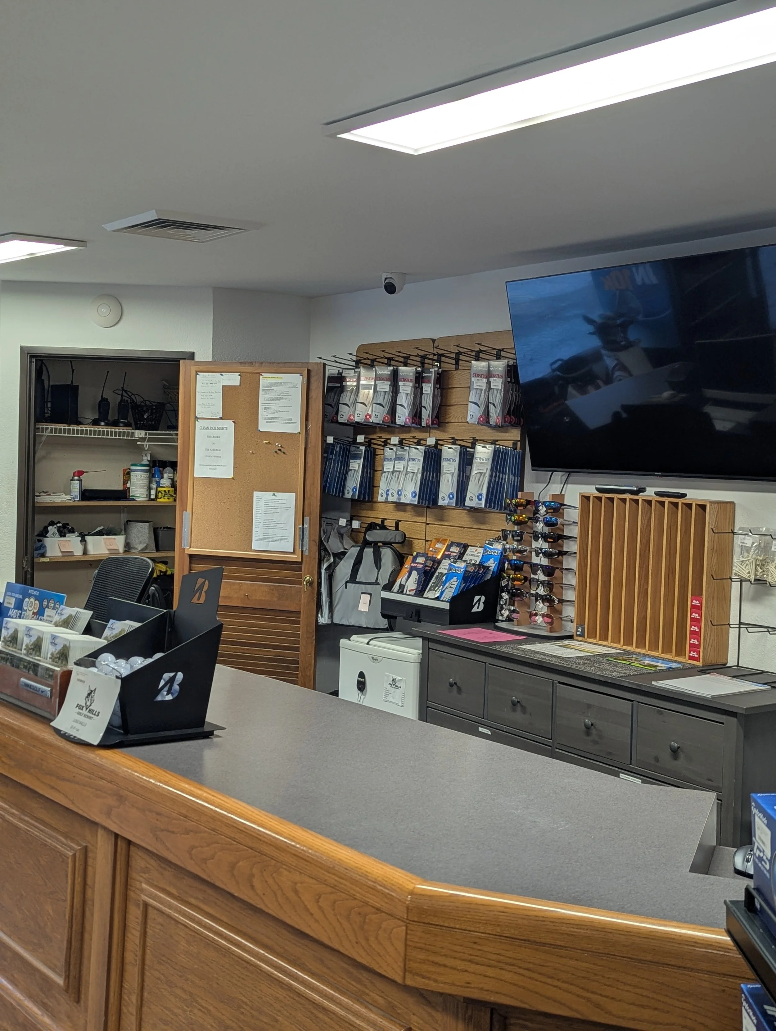 Commercial security camera installation inside golf course pro shop with counter view