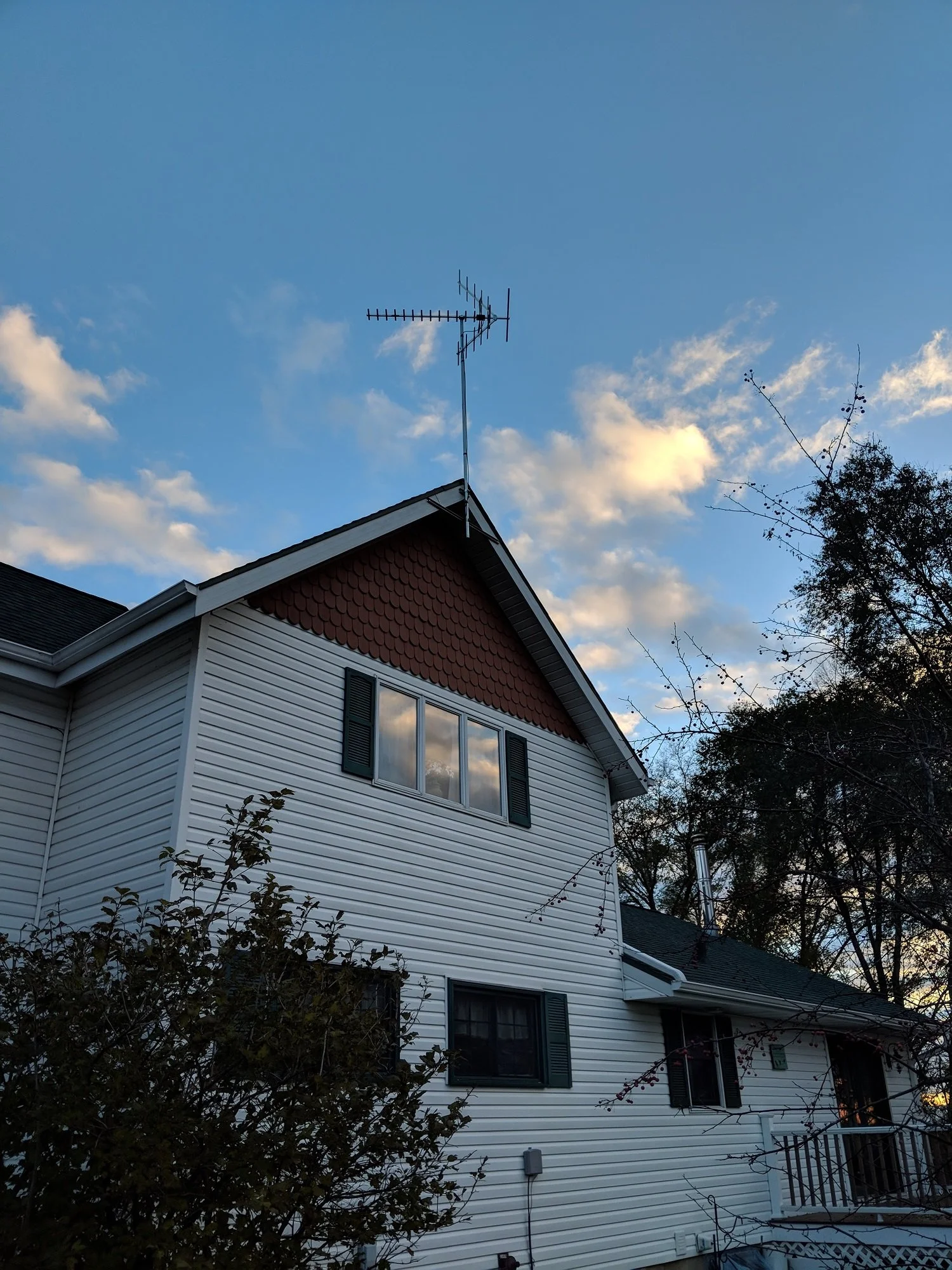 2 story gable mounted TV antenna installed on rural property to maximize line of sight.