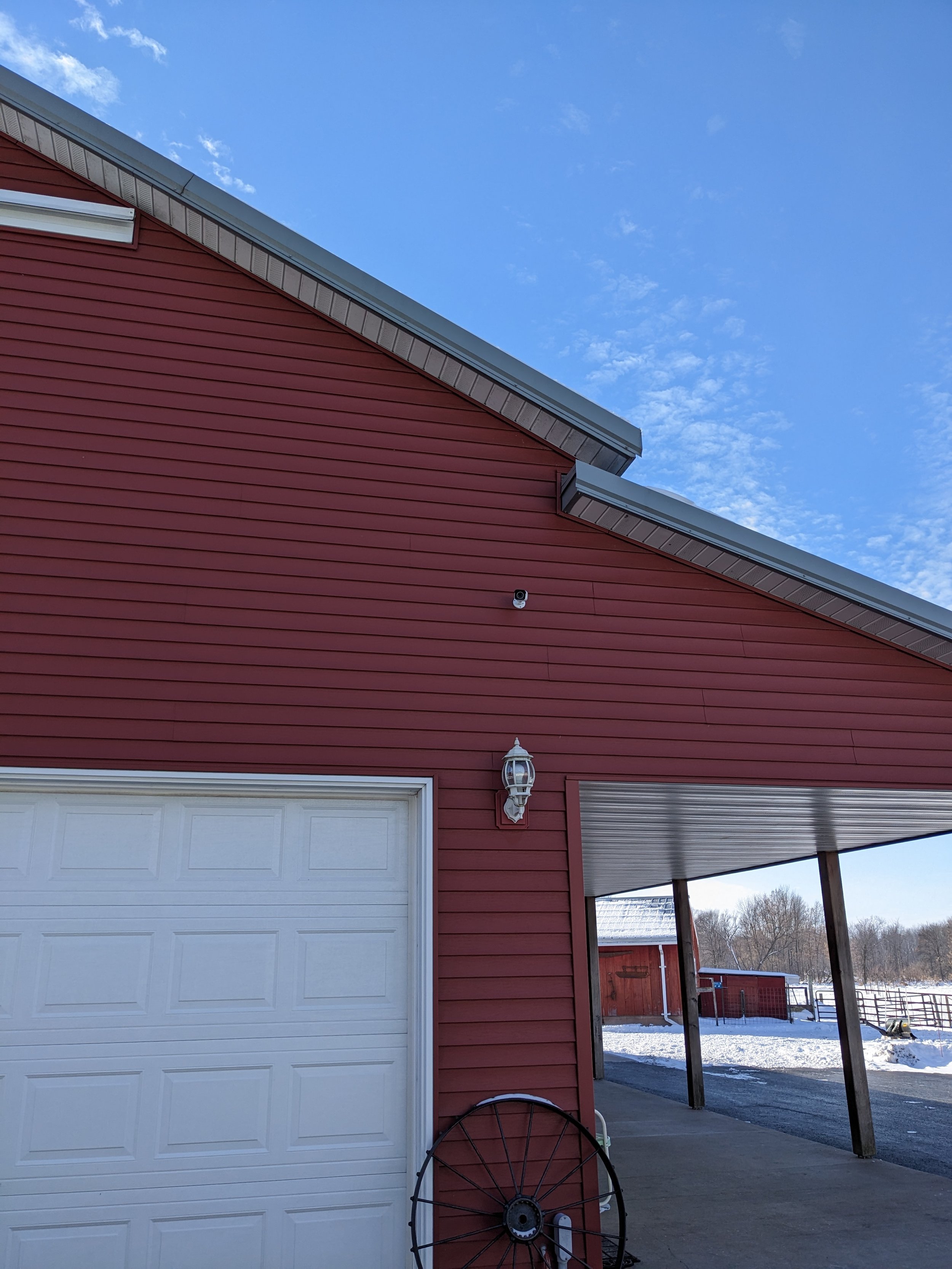 Outdoor security camera installation on garage for farm property monitoring