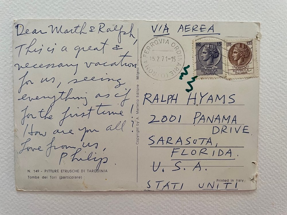  POSTCARD Postmark: 15.2.71, Roma Ferrovia  VIA AEREA  Addressed to: RALPH HYAMS 2001 PANAMA DRIVE SARASOTA, FLORIDA U.S.A.  STATI UNITI  Dear Marth [sic] &amp; Ralph,  This is a great &amp; necessary vacation for us, seeing everything as if for the 