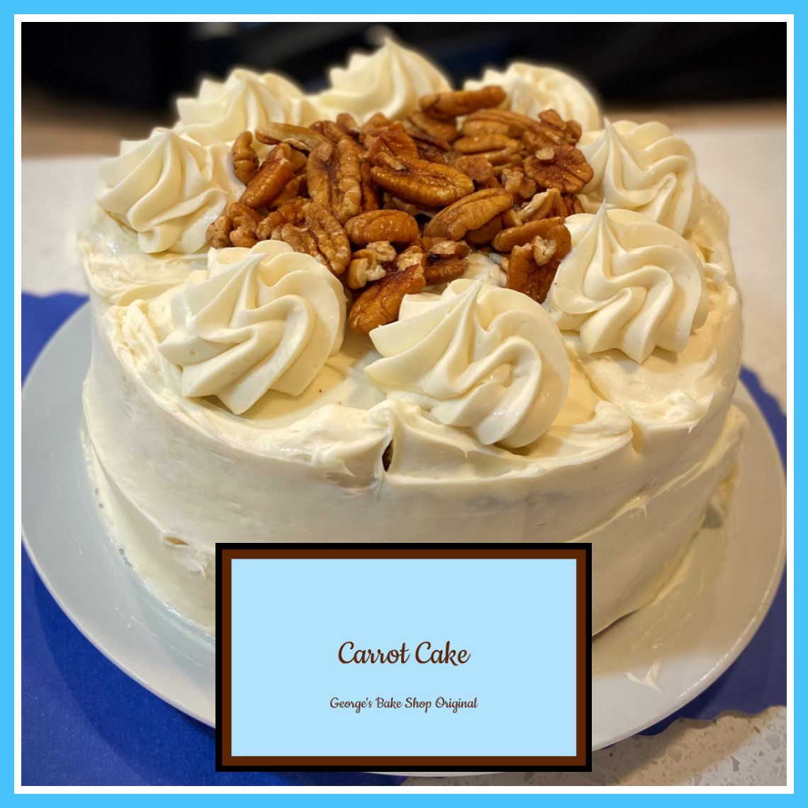 A carrot cake decorated with white frosting rosettes and topped with pecans, on a white plate. A label at the bottom reads 'Carrot Cake, George's Bake Shop Original.'