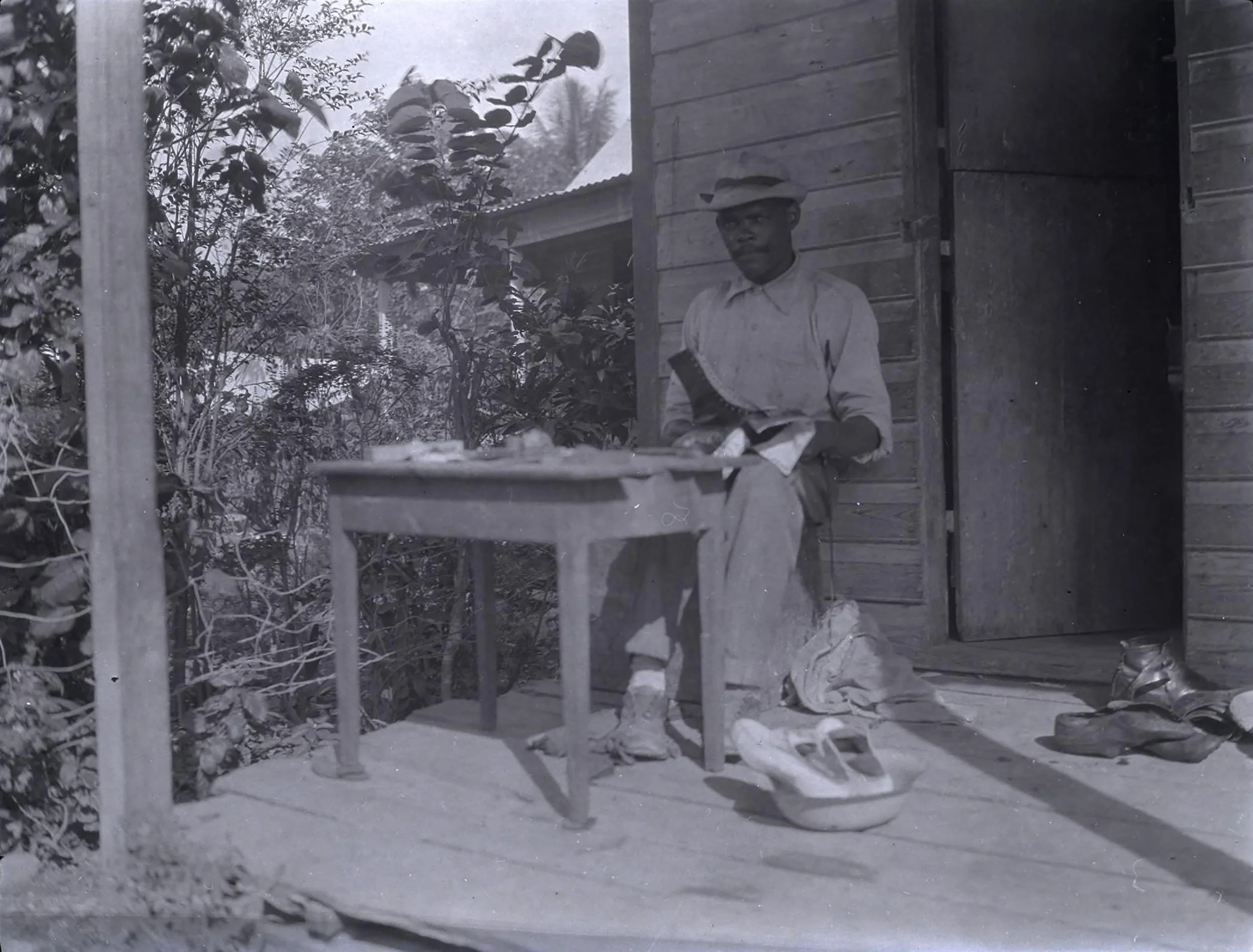 Early 1900s historic photograph of cobbler in Haiti.