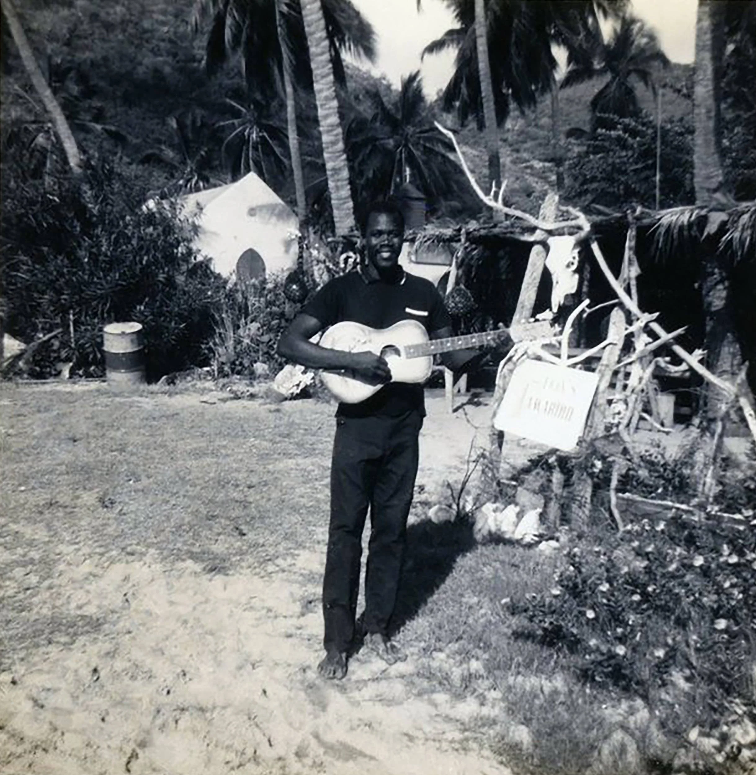 Black and white photograph on Jost Van Dyke with the Methodist Chapel in the background.