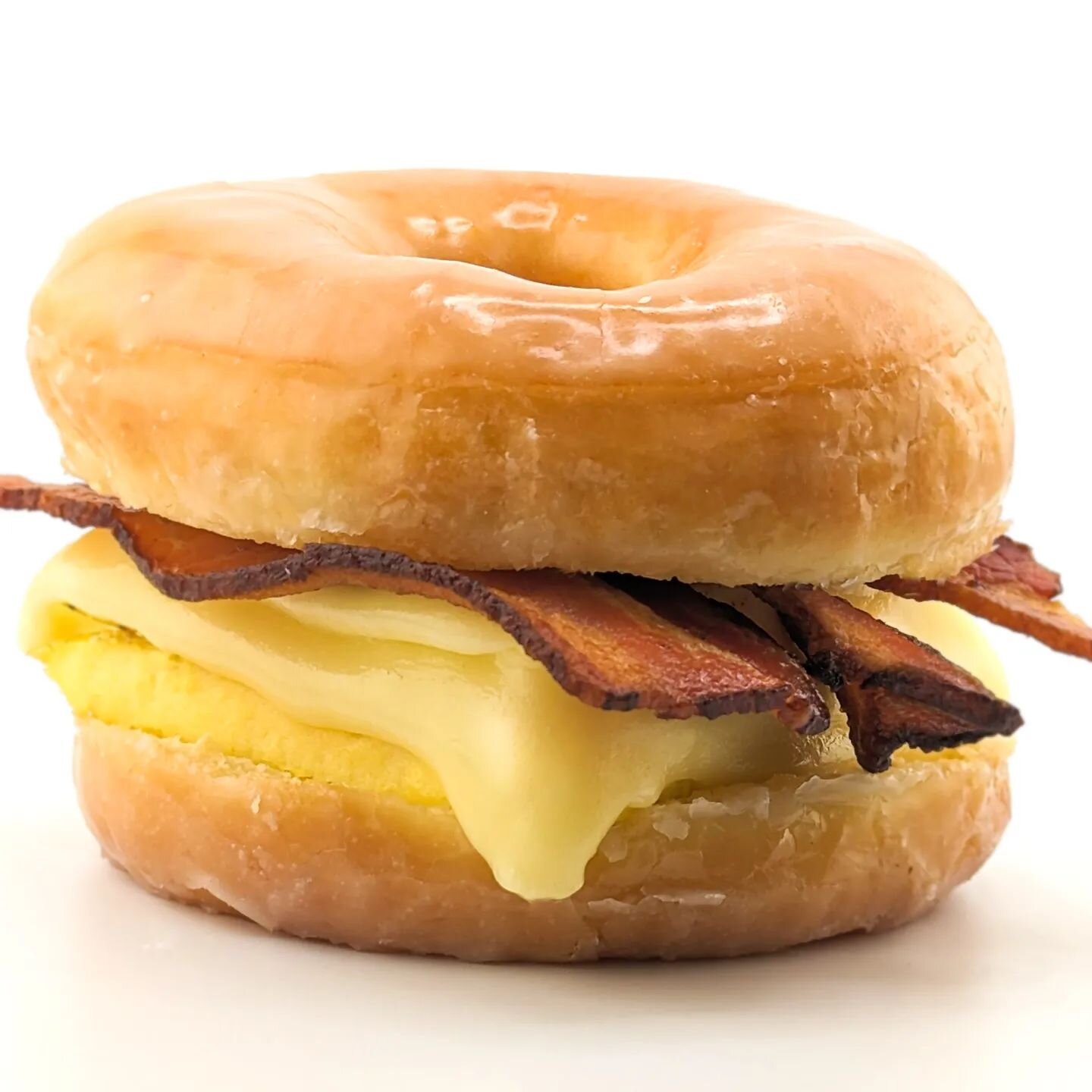 It's aaaallll happenin': Applewood smoked bacon, melty cheese, and fresh eggs between a big double glazed #donut. *8-11am daily as supplies last