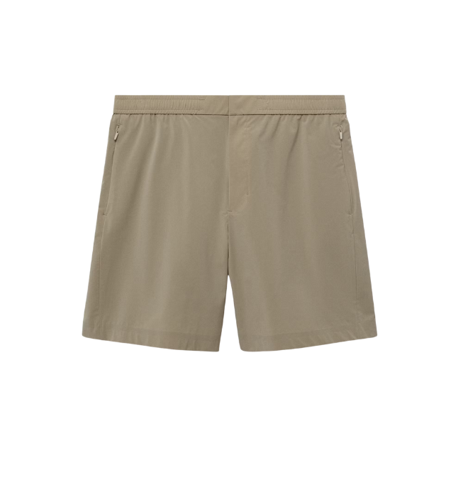 Beige athletic shorts with zippers on the sides