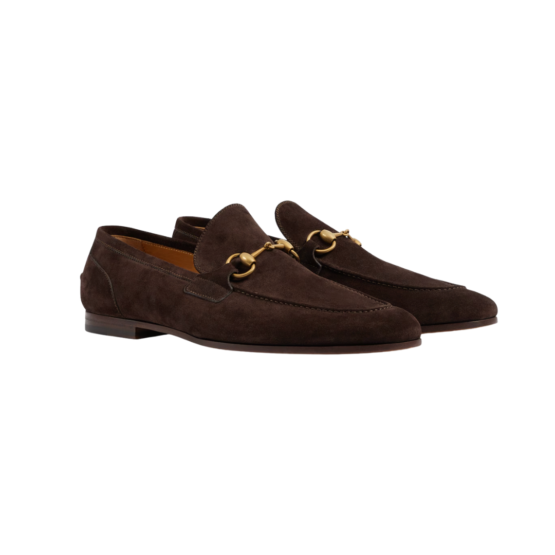 Pair of brown suede loafers with gold horsebit accents.