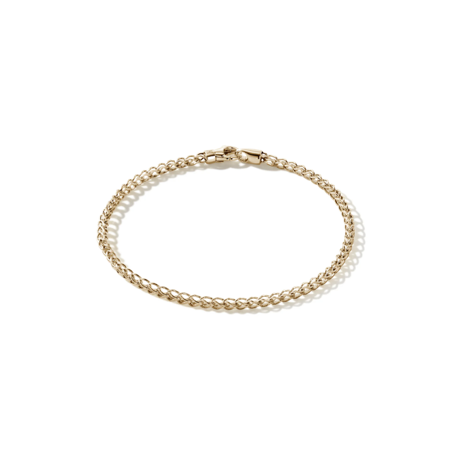 Gold chain bracelet with a toggle clasp on a white background.
