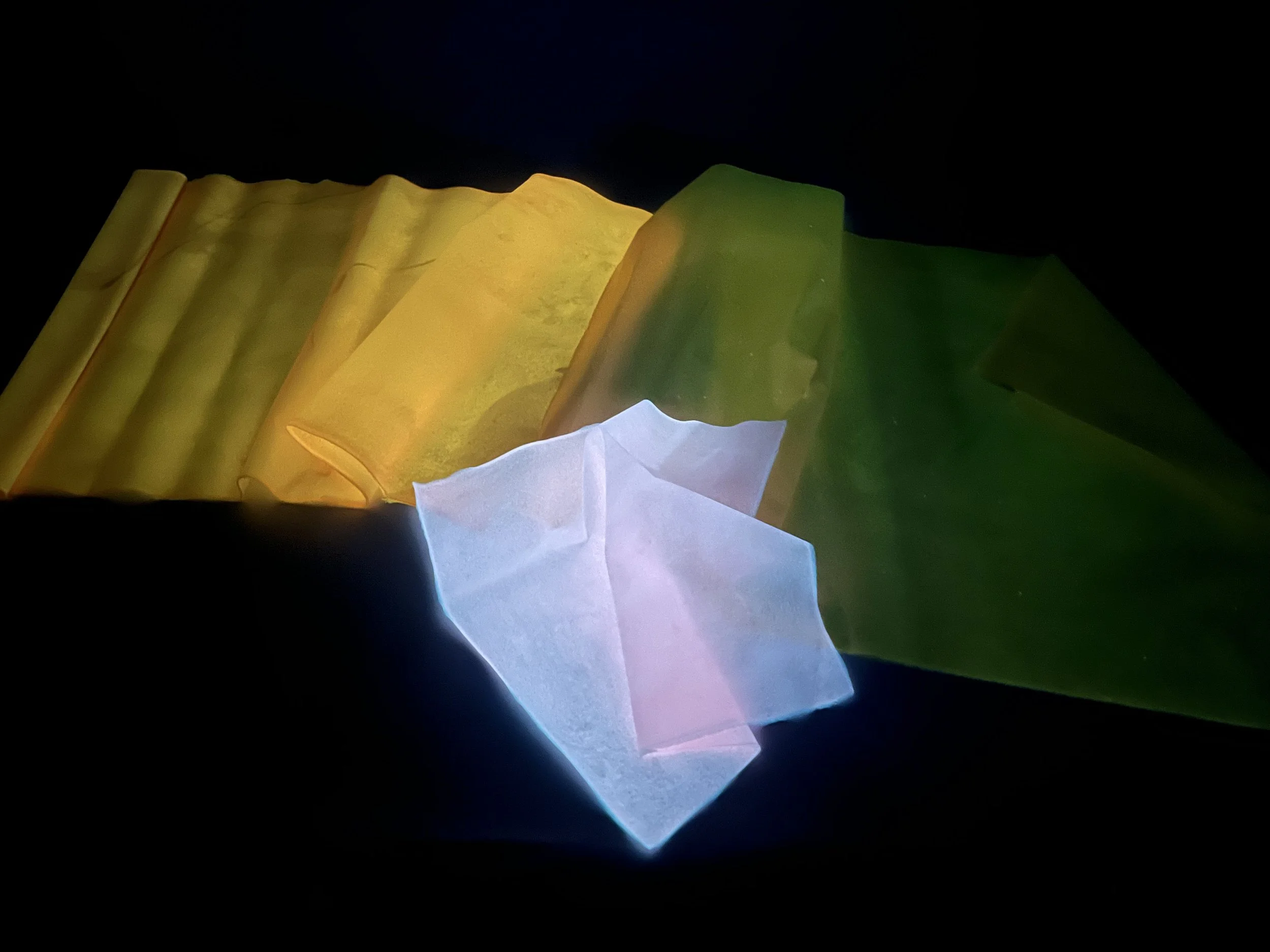 Bioplastic sheets glowing under light, revealing their translucency and shifting tones, a reminder that Rai’s materials are not static, but responsive and alive.