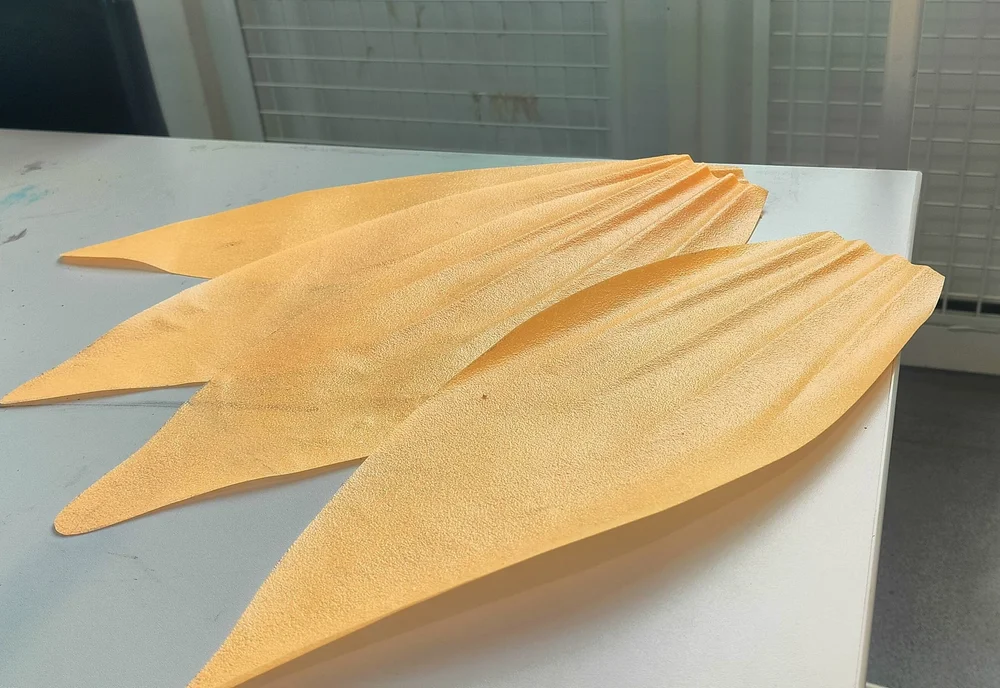 Petal-shaped sheets echo natural forms, blending tradition with contemporary biomaterials.