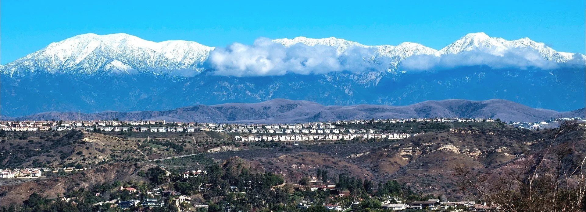 Snow-capped San Bernardino Mountains rising above the high-desert communities of Southern California