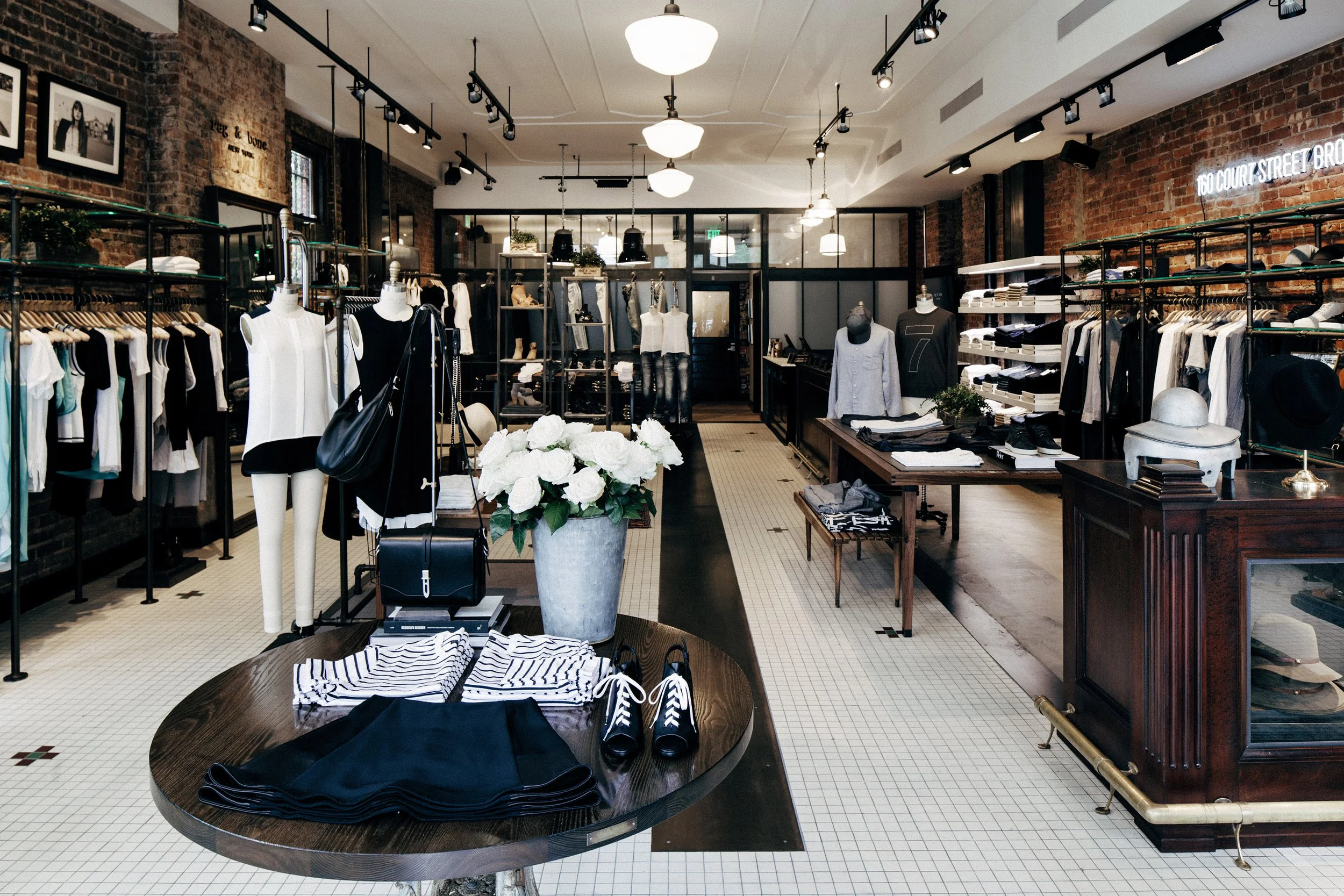 BLD commercial retail adaptive reuse in Brooklyn, New York includes remnets of the former bar, transparent entry creating a welcoming transition from the street, thoughtful zoning for apparel, accessories, and fitting areas
