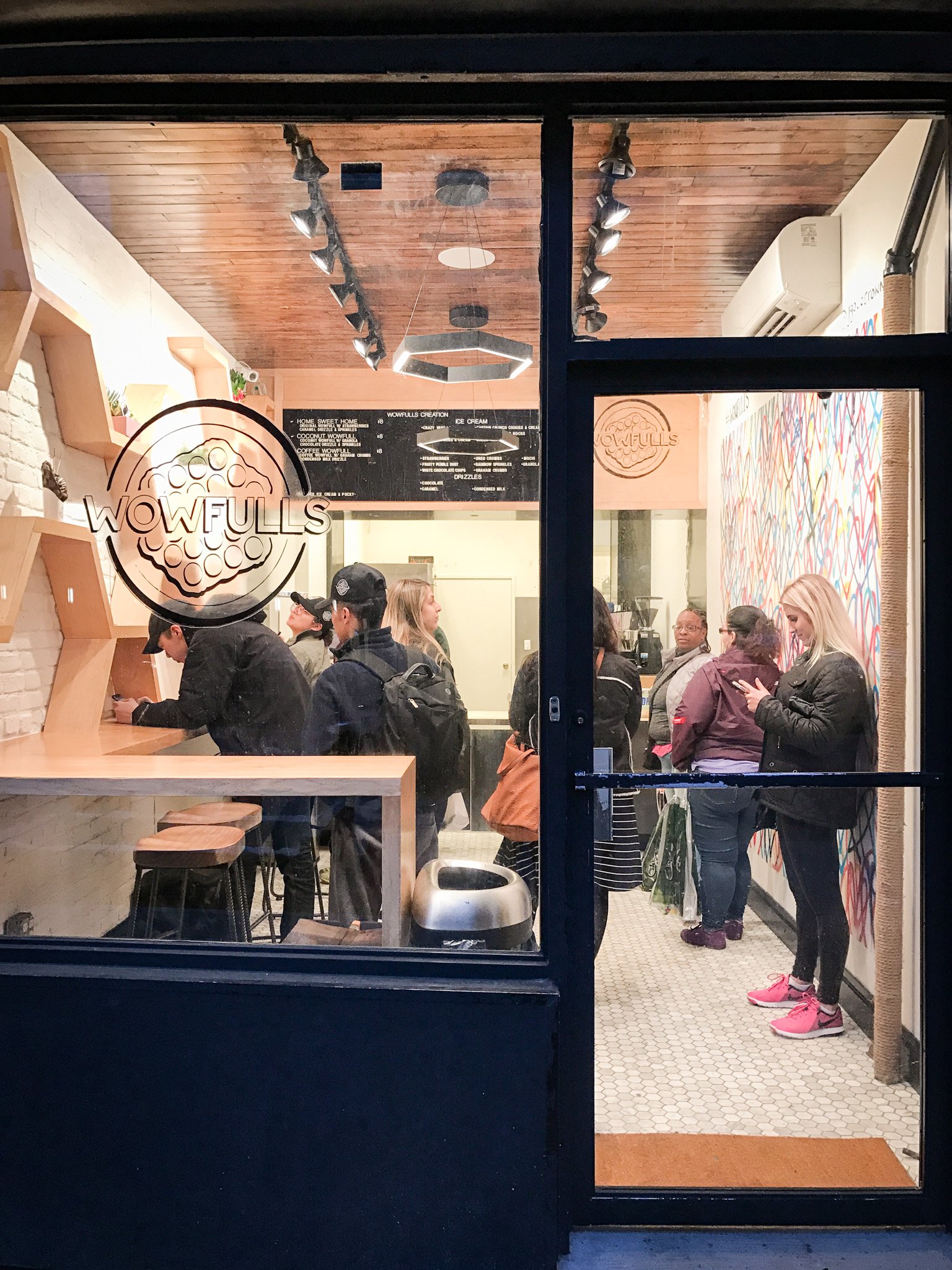 BLD Inc commerical food place in New York, incorporates traditional shape of the original Hong Kong style egg waffles to create functional display shelves, and easy movement for waffle artists