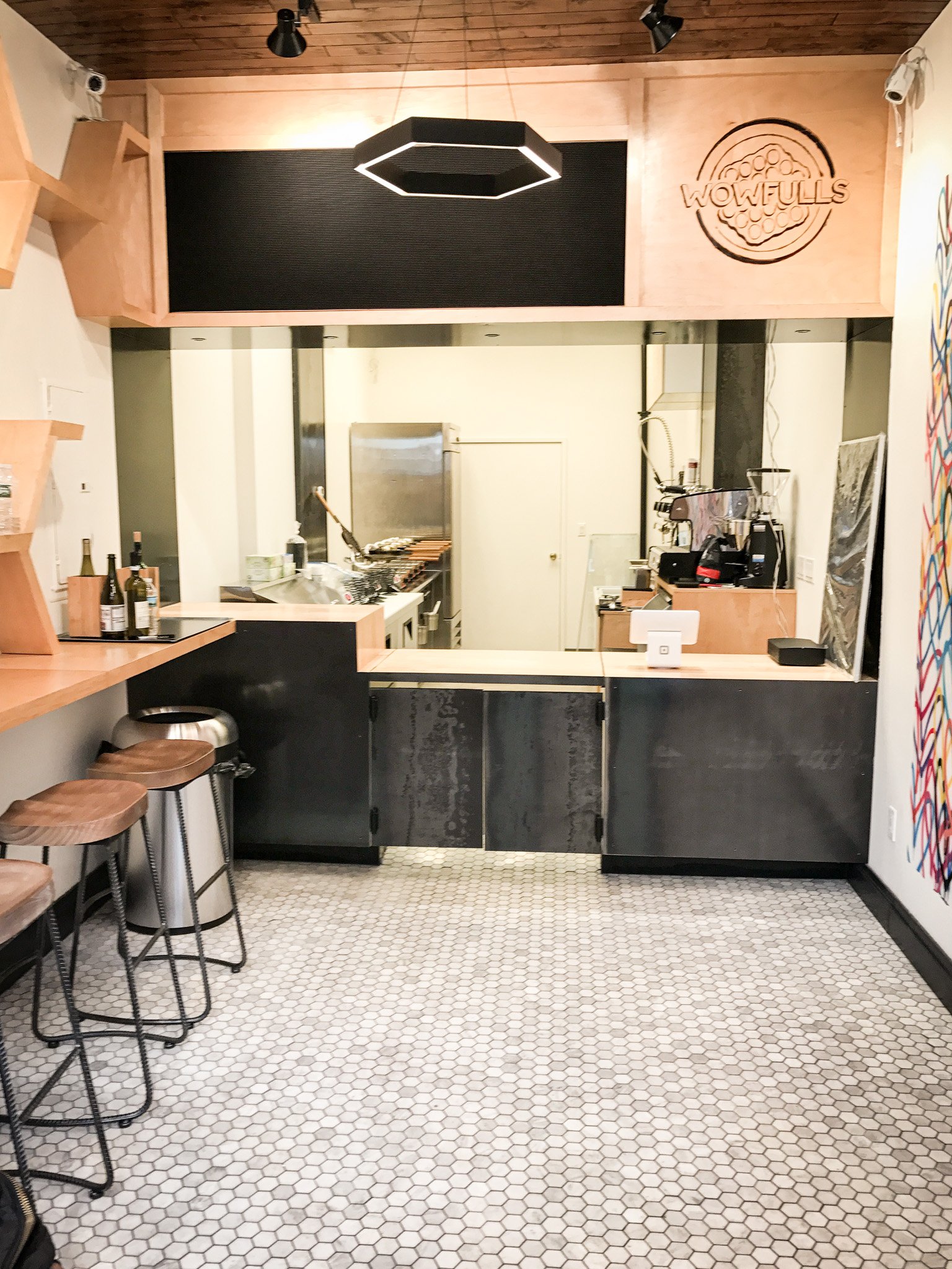 BLD Inc commerical food place in New York, incorporates traditional shape of the original Hong Kong style egg waffles to create functional display shelves, and easy movement for waffle artists