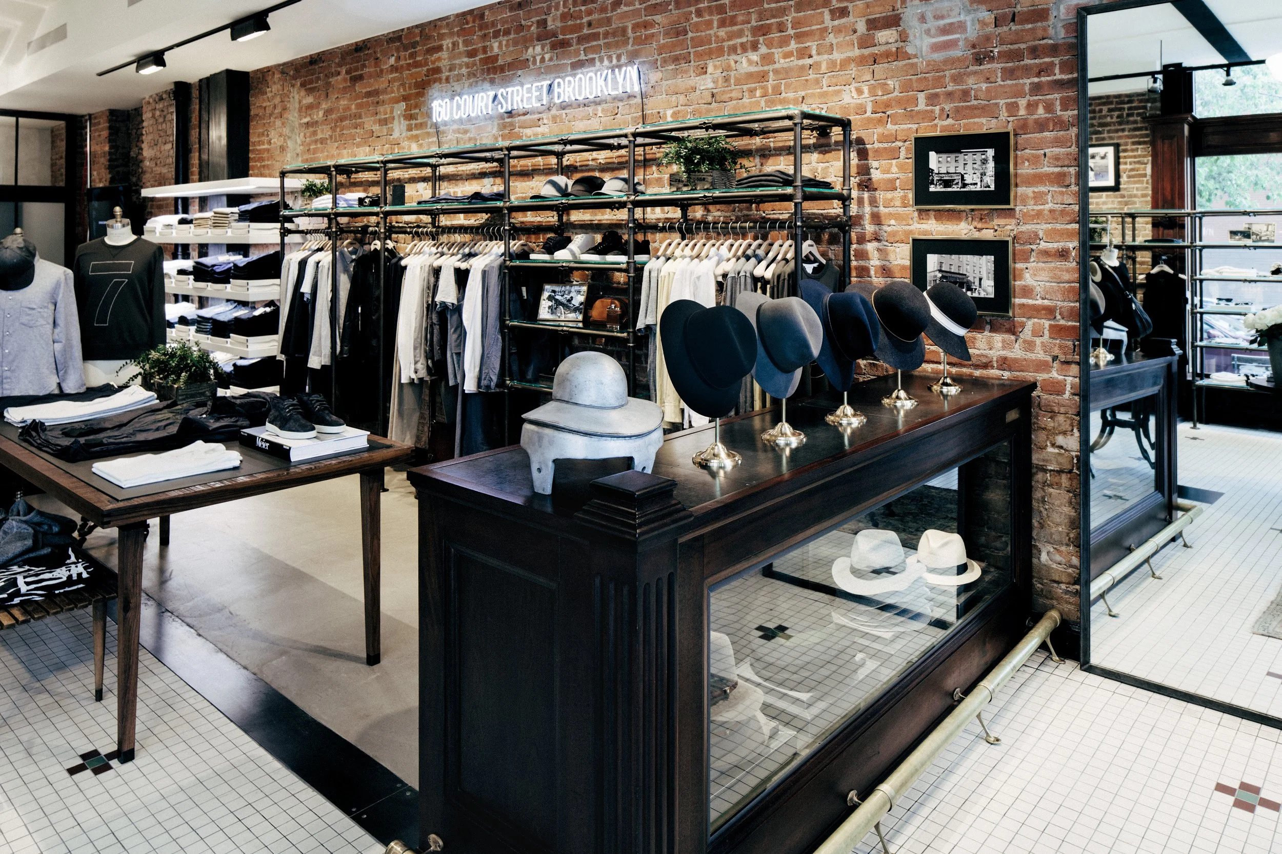 BLD commercial retail adaptive reuse in Brooklyn, New York includes remnets of the former bar, transparent entry creating a welcoming transition from the street, thoughtful zoning for apparel, accessories, and fitting areas