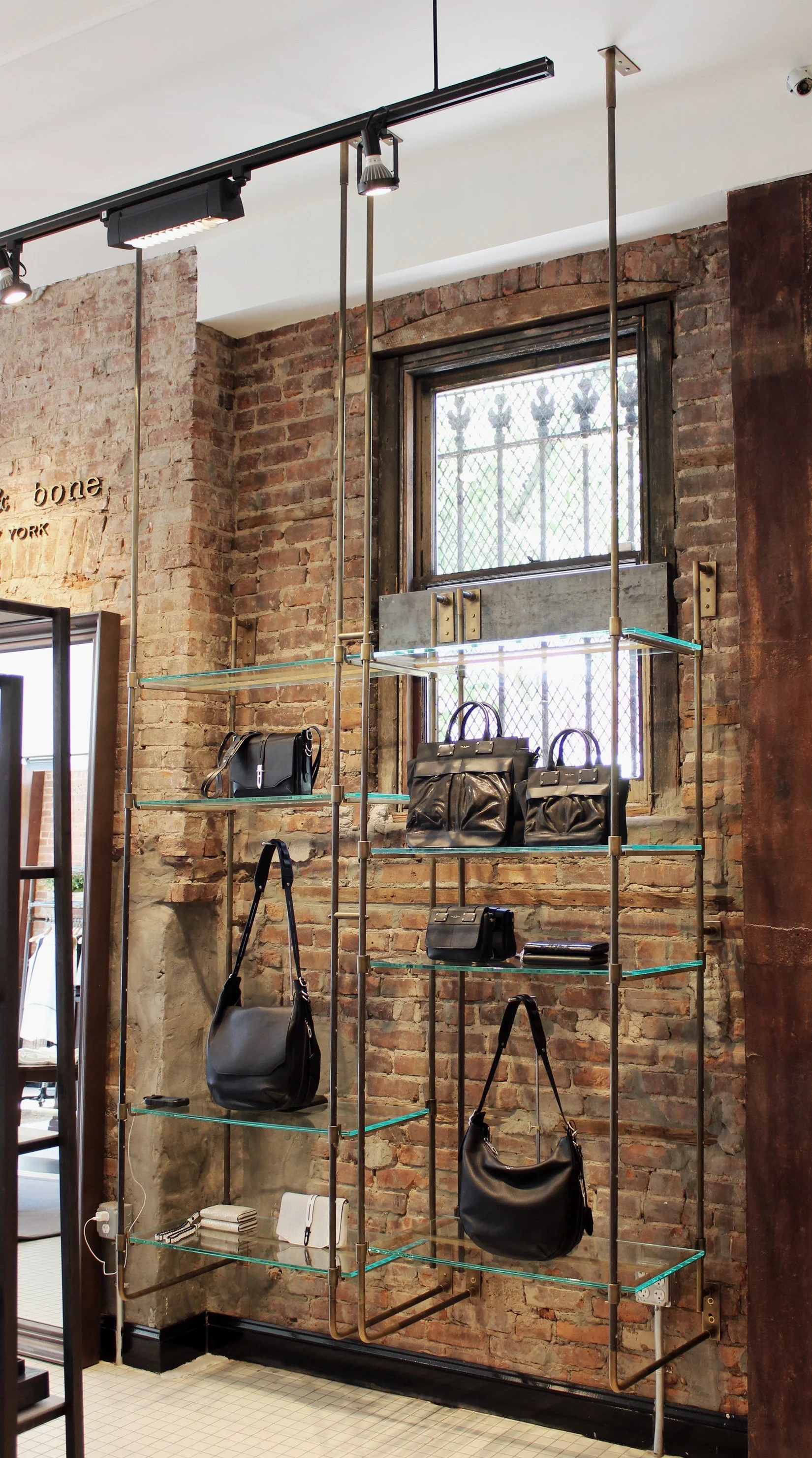 BLD commercial retail adaptive reuse in Brooklyn, New York includes remnets of the former bar, transparent entry creating a welcoming transition from the street, thoughtful zoning for apparel, accessories, and fitting areas