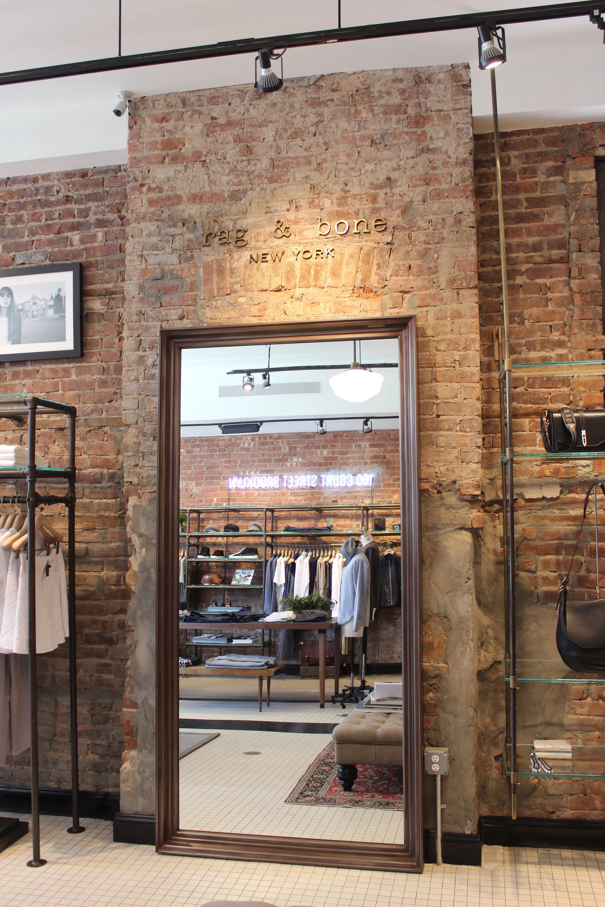 BLD commercial retail adaptive reuse in Brooklyn, New York includes remnets of the former bar, transparent entry creating a welcoming transition from the street, thoughtful zoning for apparel, accessories, and fitting areas