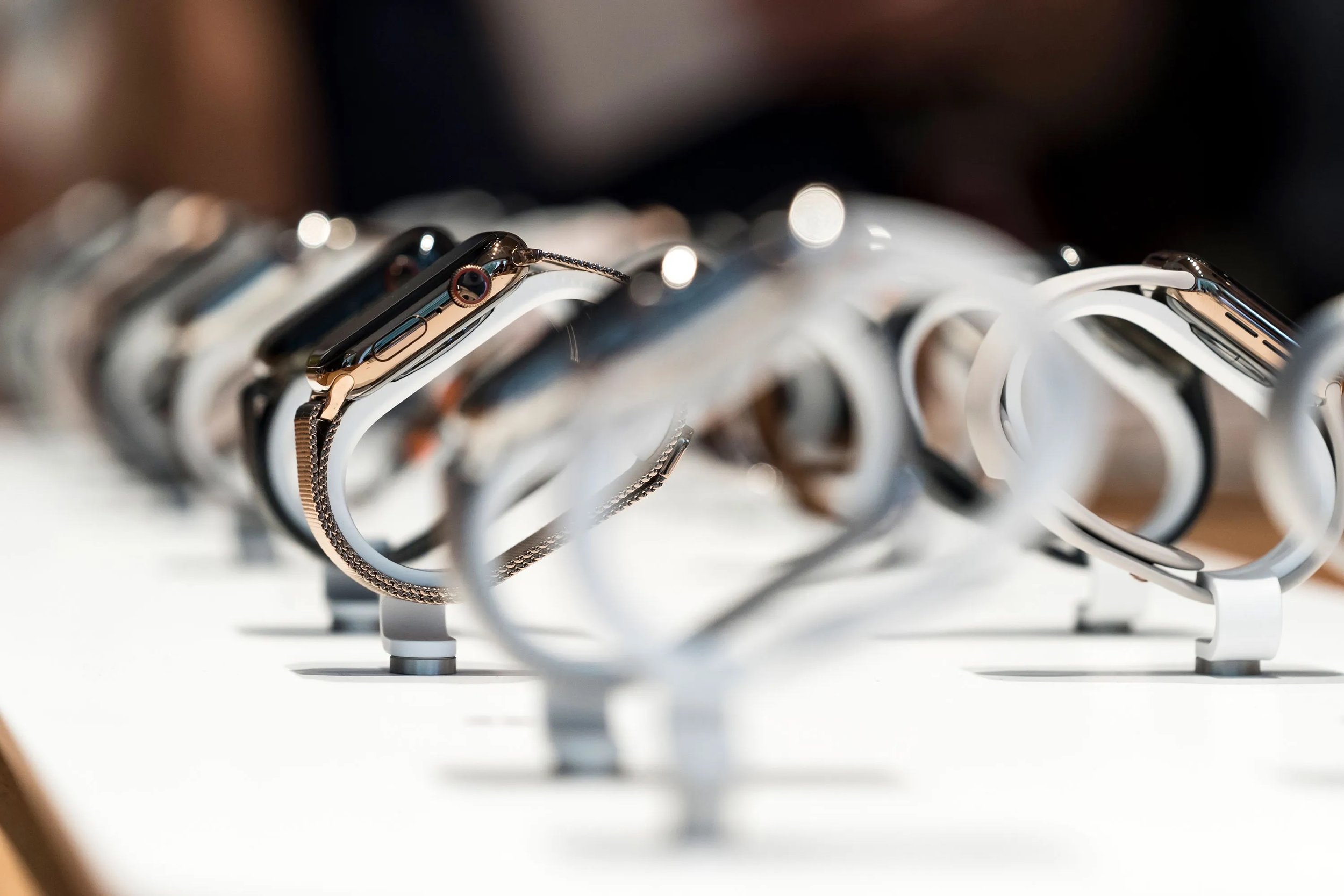 Apple Watches on display in stores. I worked on the metal structure that holds and charges the phones.