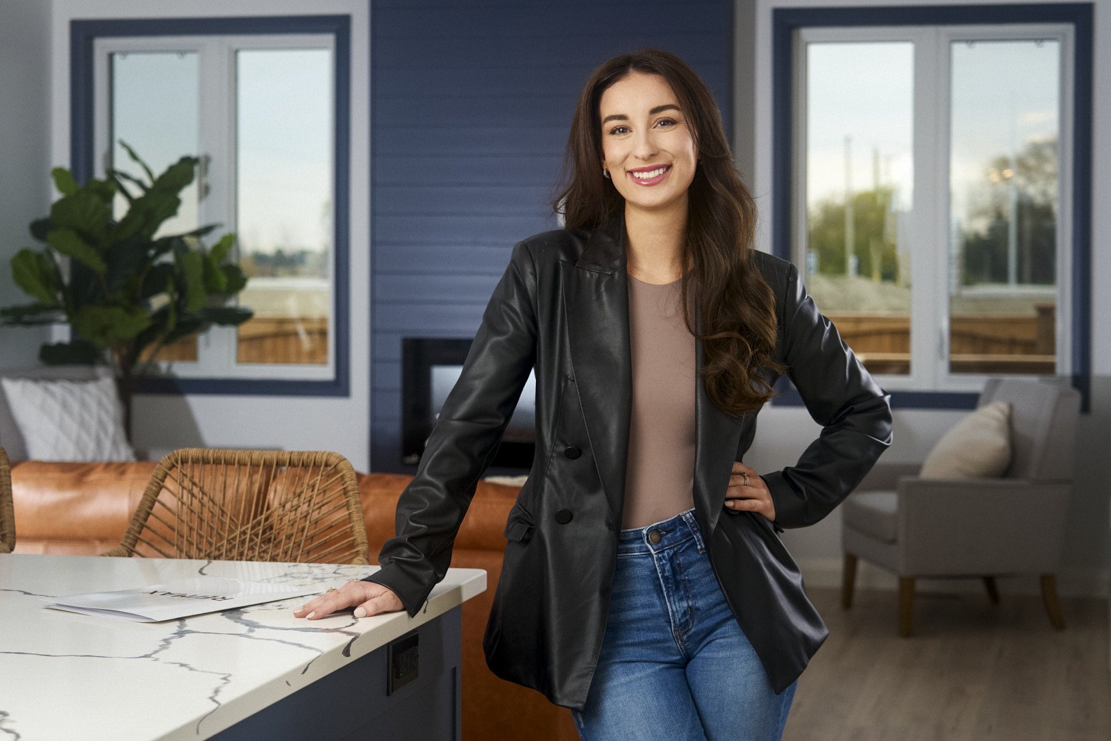 woman in kitchen wearing leather jacket