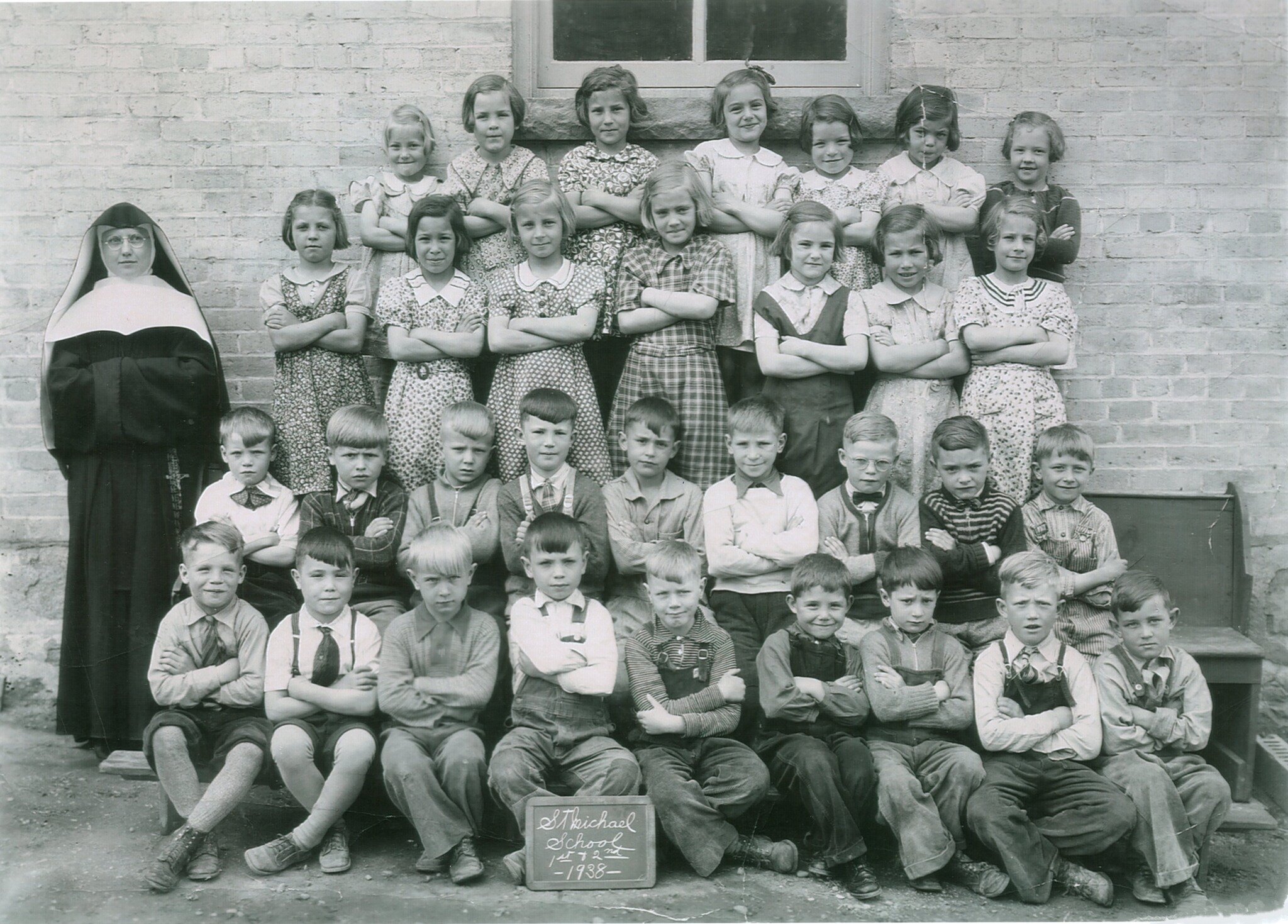 Pictured here are Sr. Gertrude Fasnacht and the 1st and 2nd graders of St. Michael&rsquo;s Parish School in 1938. All of the following surnames of the girls are their original family surnames. Starting on the top row from left: Dolores Kasper, Norita