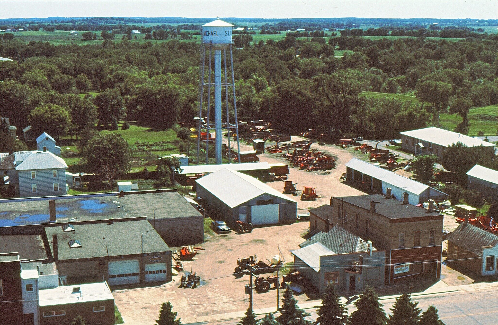 Louis Welter took this photo from the church steeple in 1973. At the lower left is the office of Dr. Jim Chervenak which he built about three years before. Above that are the rear portions of Welter&rsquo;s Implement and the Wright County Co-Op, and 