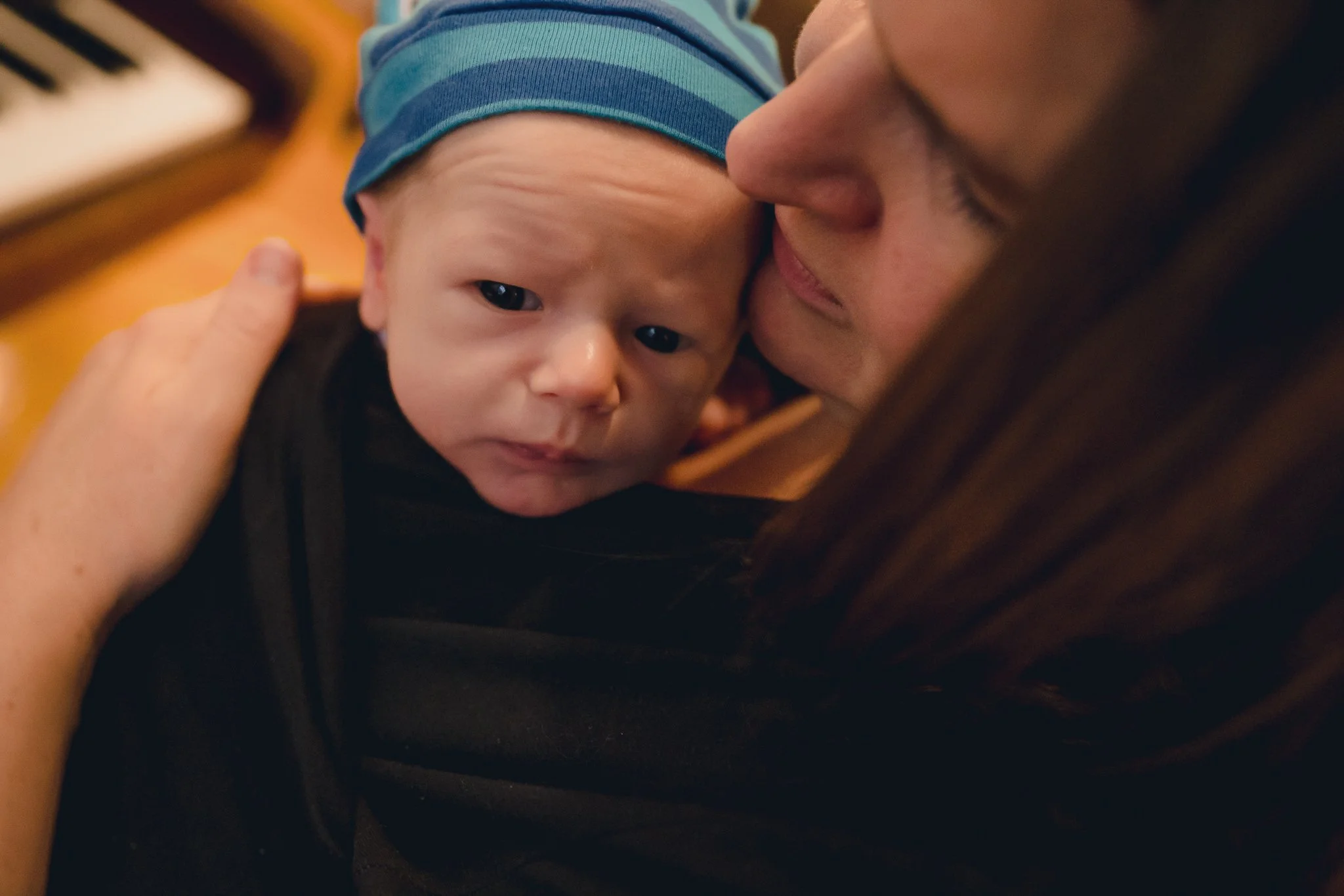 close up of mother holding infant son close