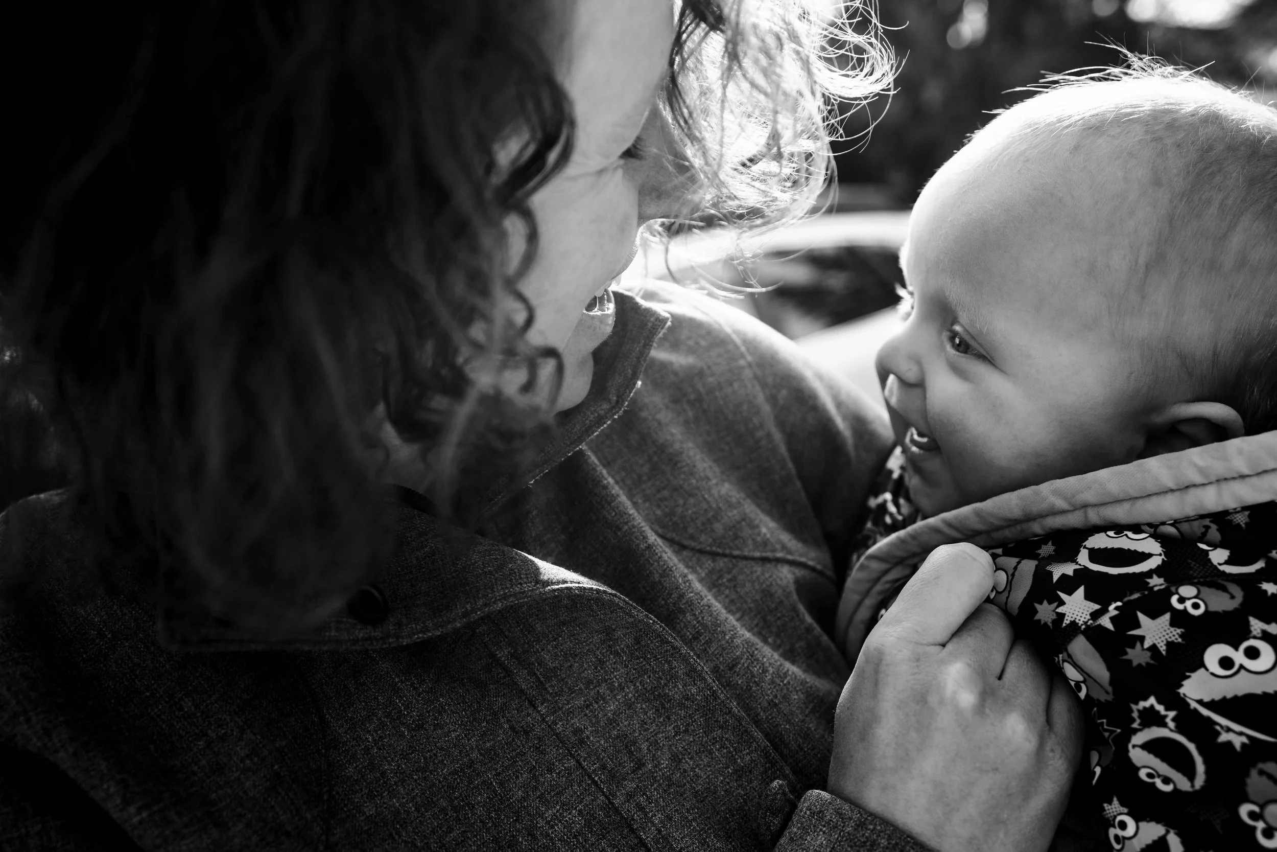 Mom holding her baby and smiling at her during an everyday family moment