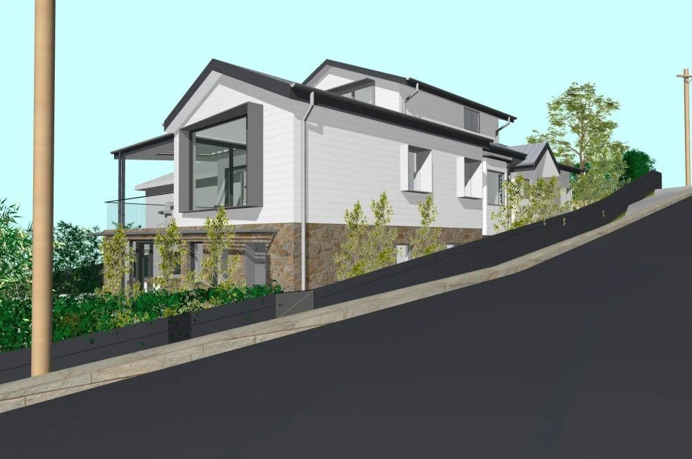 A modern two-story house under construction on a hillside, with white siding, large windows, decorative stonework, surrounded by trees, and a sloped black asphalt road in the foreground.