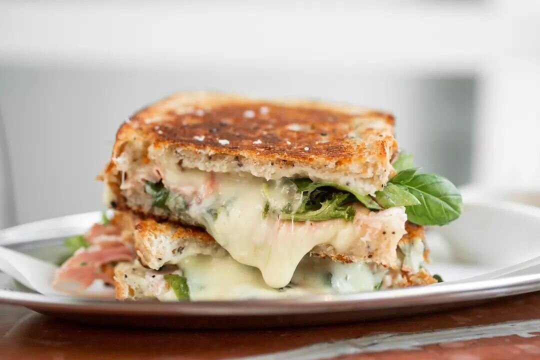 Bite into some toasty cheesy goodness with our&nbsp;4-cheese toastie: a symphony of @maffra_cheese cheddar, mozzarella, provolone &amp; pecorino. Topped with tangy pickled shallots and a bed of fresh greens. Pure satisfaction between two toasty slice