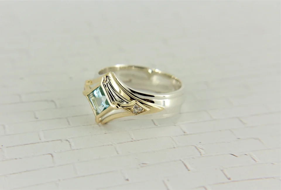 Continuum silver and yellow gold Men's band with a topaz center stone and side accent diamonds