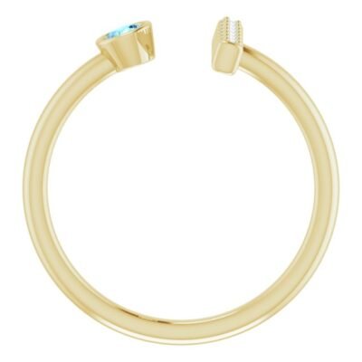 14k yellow gold split ring with a bezel set round cut aquamarine on one side and a prong-set bar of diamonds on the other side.