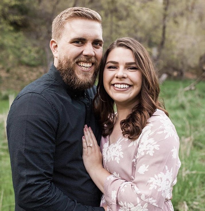  an engagement photo showing a couple smiling 