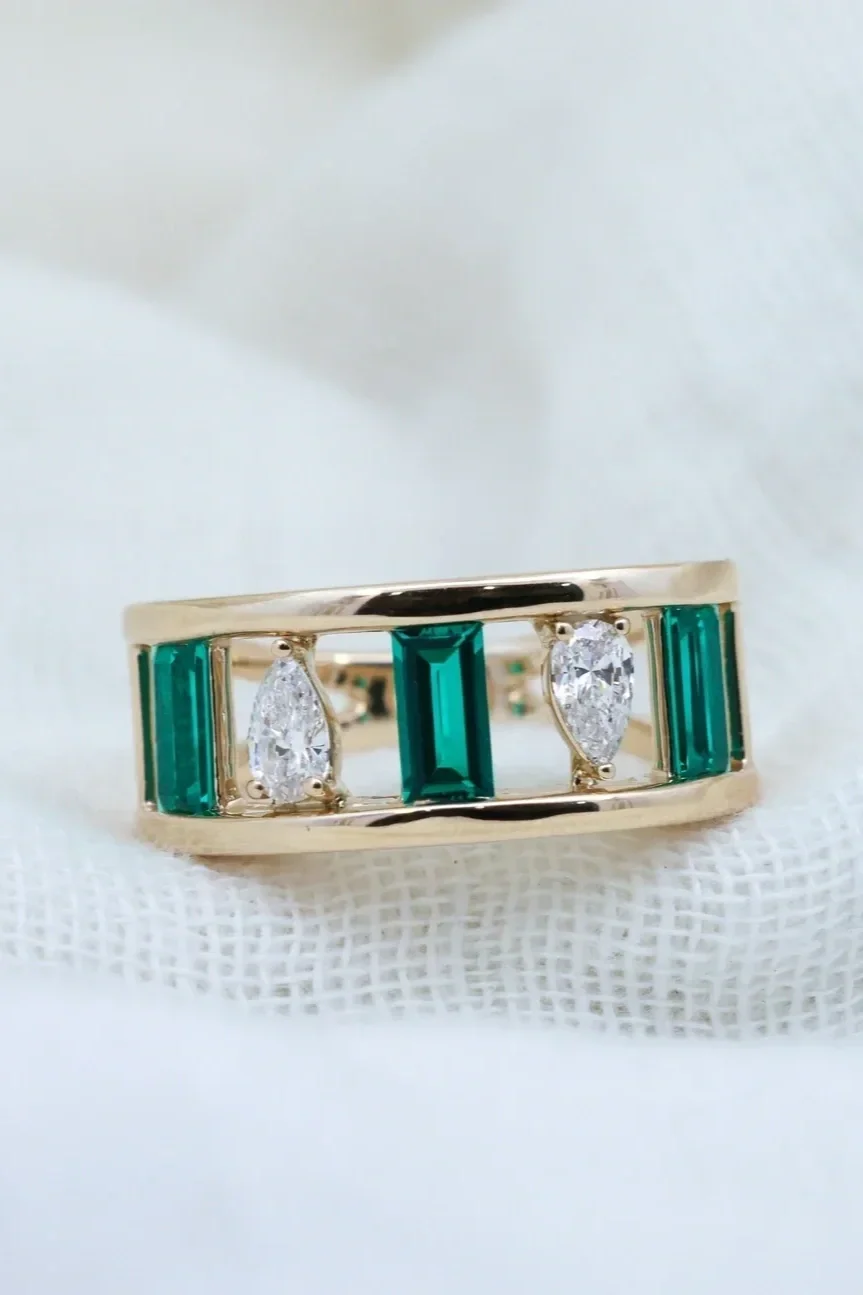 Custom yellow gold fashion ring with alternating emerald baguettes and diamond pears