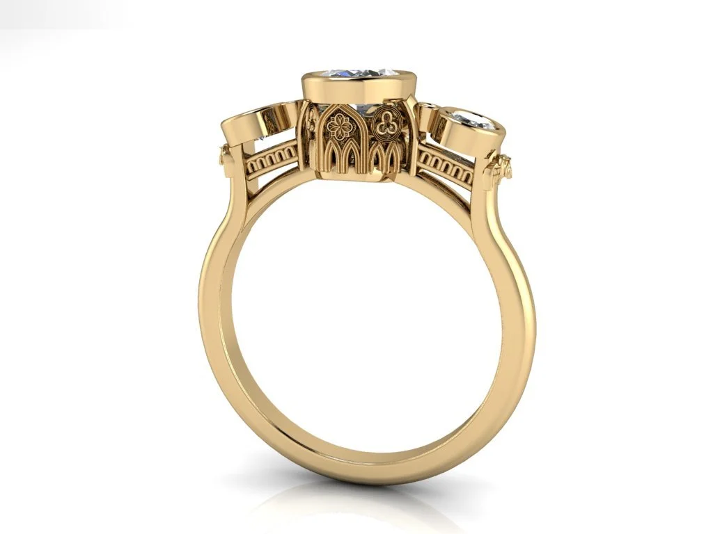 Notre Dame Inspired Ring bezel set oval three stone ring in yellow gold with notre dame motifs