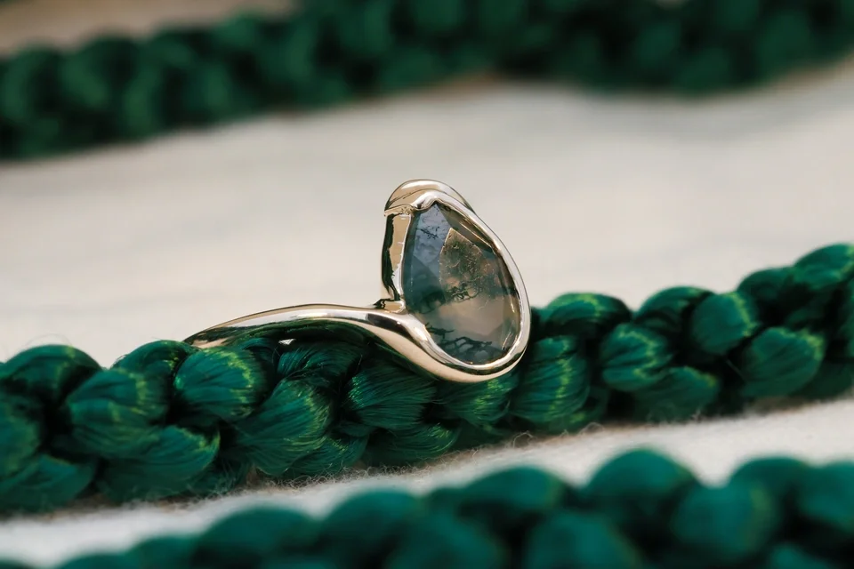 offsetOrganic partial bezel moss agate pear solitaire