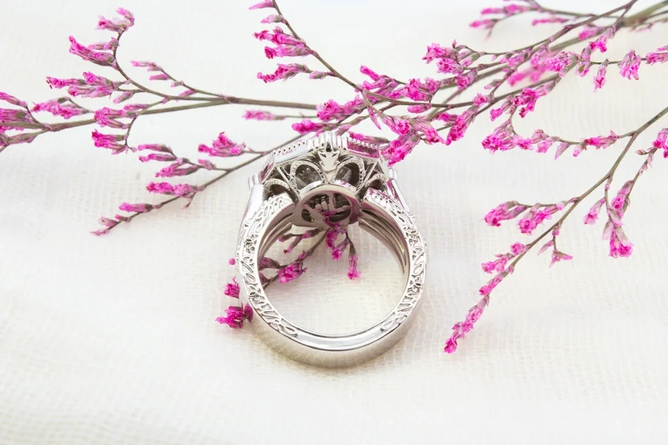 ASL wedding ring with elaborate detail on the side of the ring, and an "I love you" hand signal in gold placed in the gallery