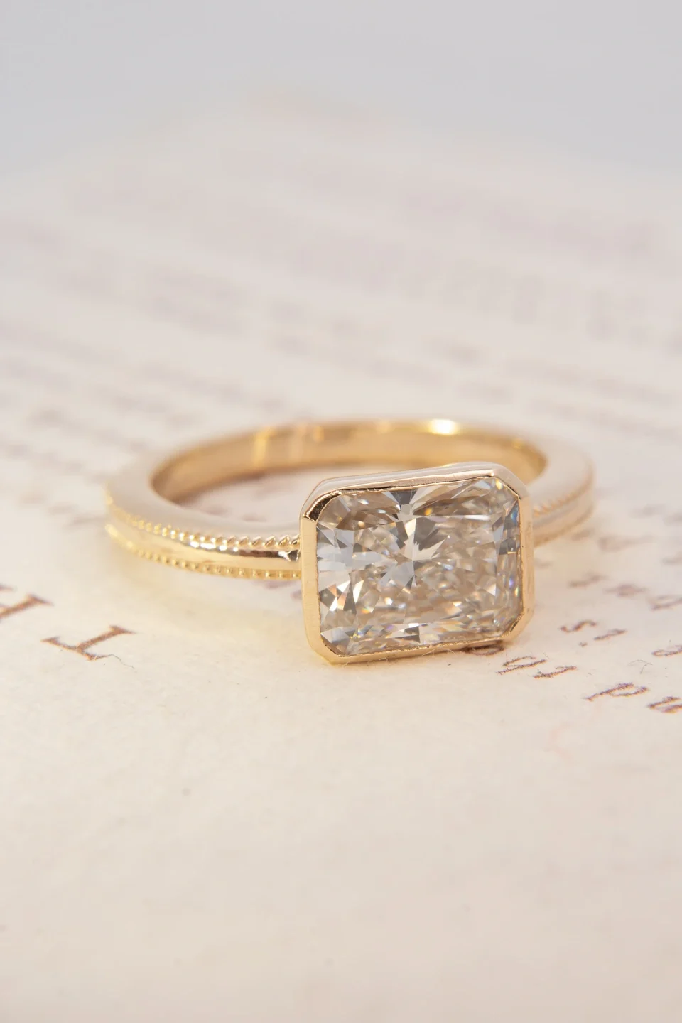 East-West Set Milgrain Ring with Radiant Cut Diamond in yellow gold