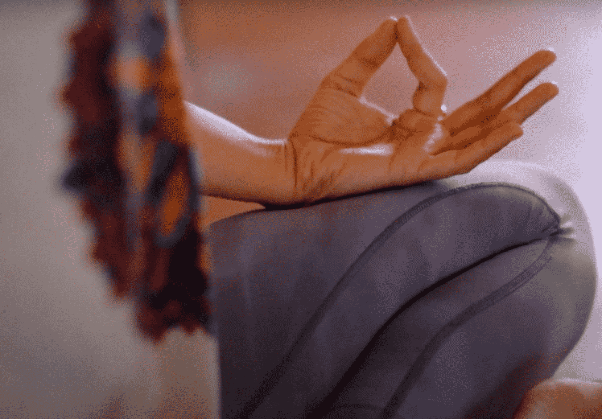 A hand resting in a meditation mudra at a Yukah programme