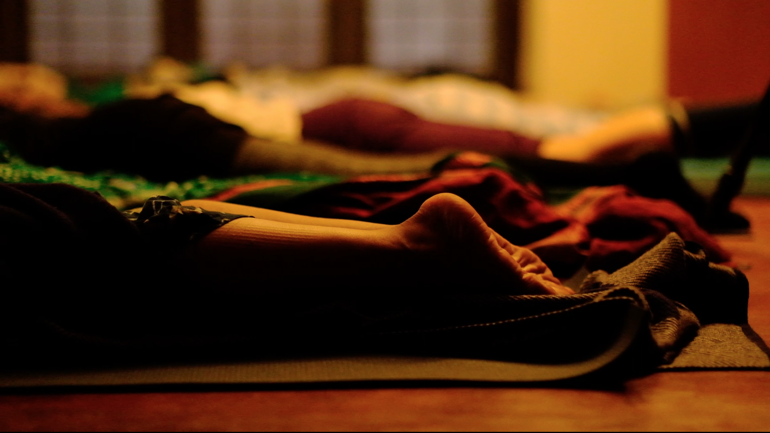 Participants lying in deep rest at the end of a yoga session at Yukah.