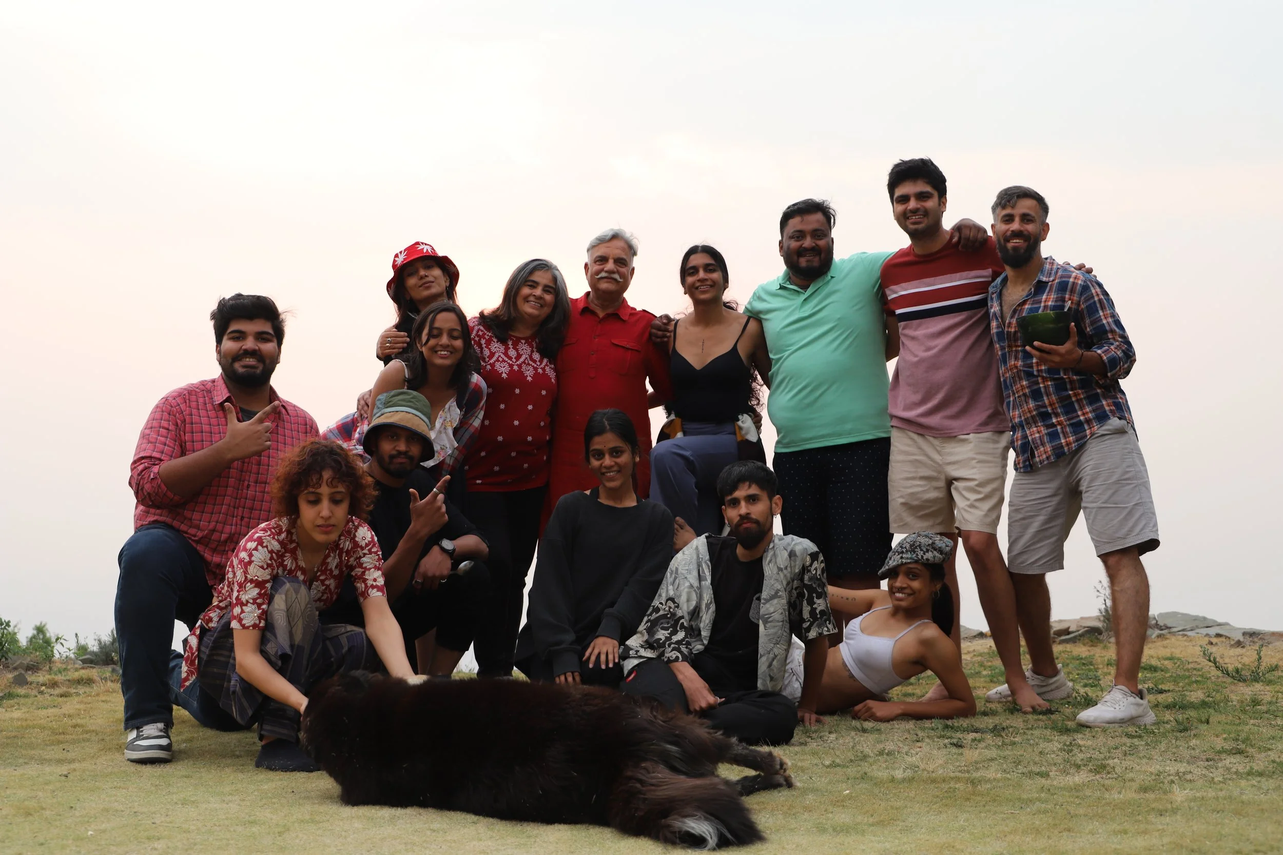 Participants and a friendly dog on a hilltop at a Yukah gathering.
